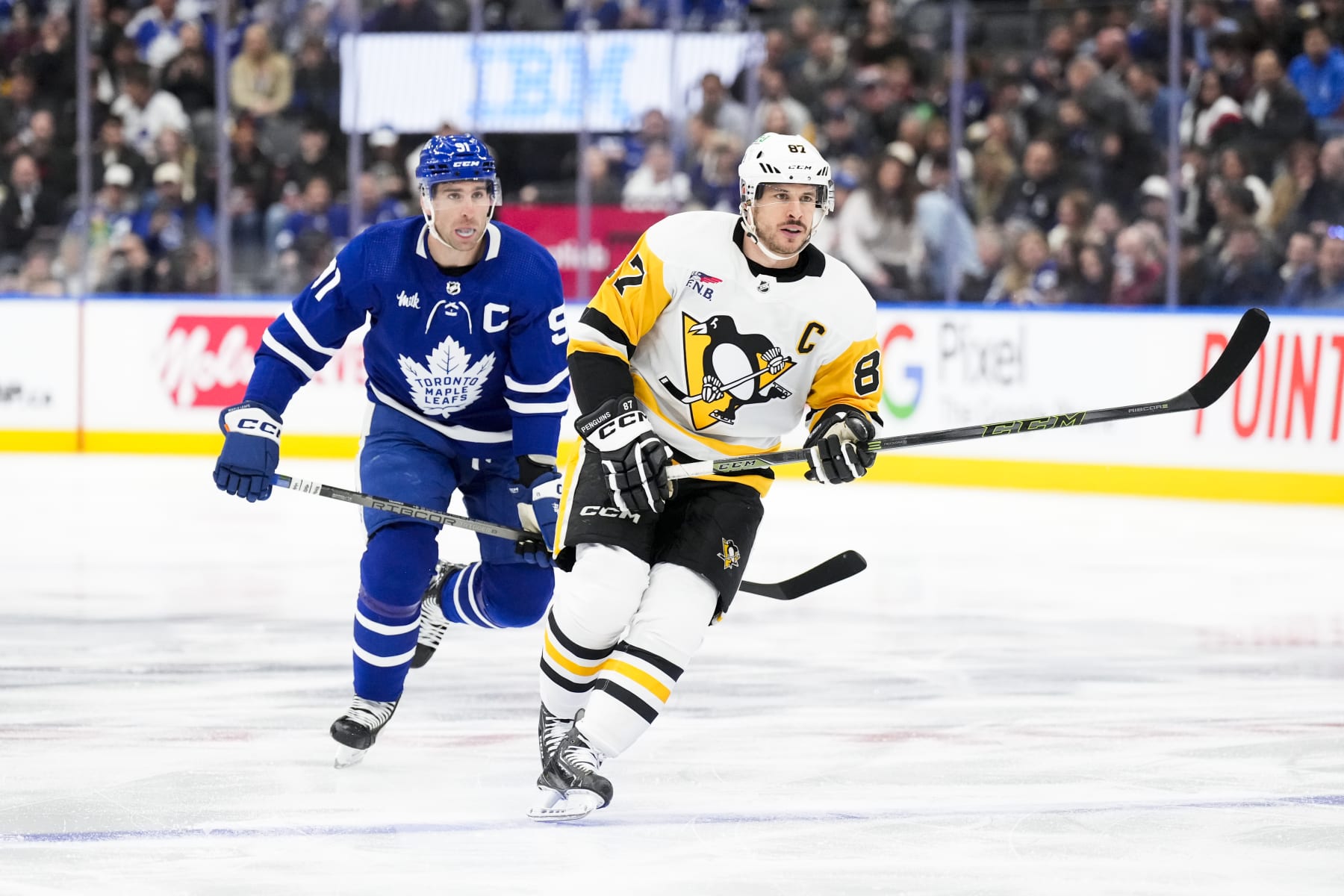 TORONTO, ON - APRIL 8: Sidney Crosby #87 of the Pittsburgh Penguins battles against John Tavares #91 of the Toronto Maple Leafs during the first period at Scotiabank Arena on April 8, 2024 in Toronto, Ontario, Canada. (Photo by Kevin Sousa/NHLI via Getty Images)