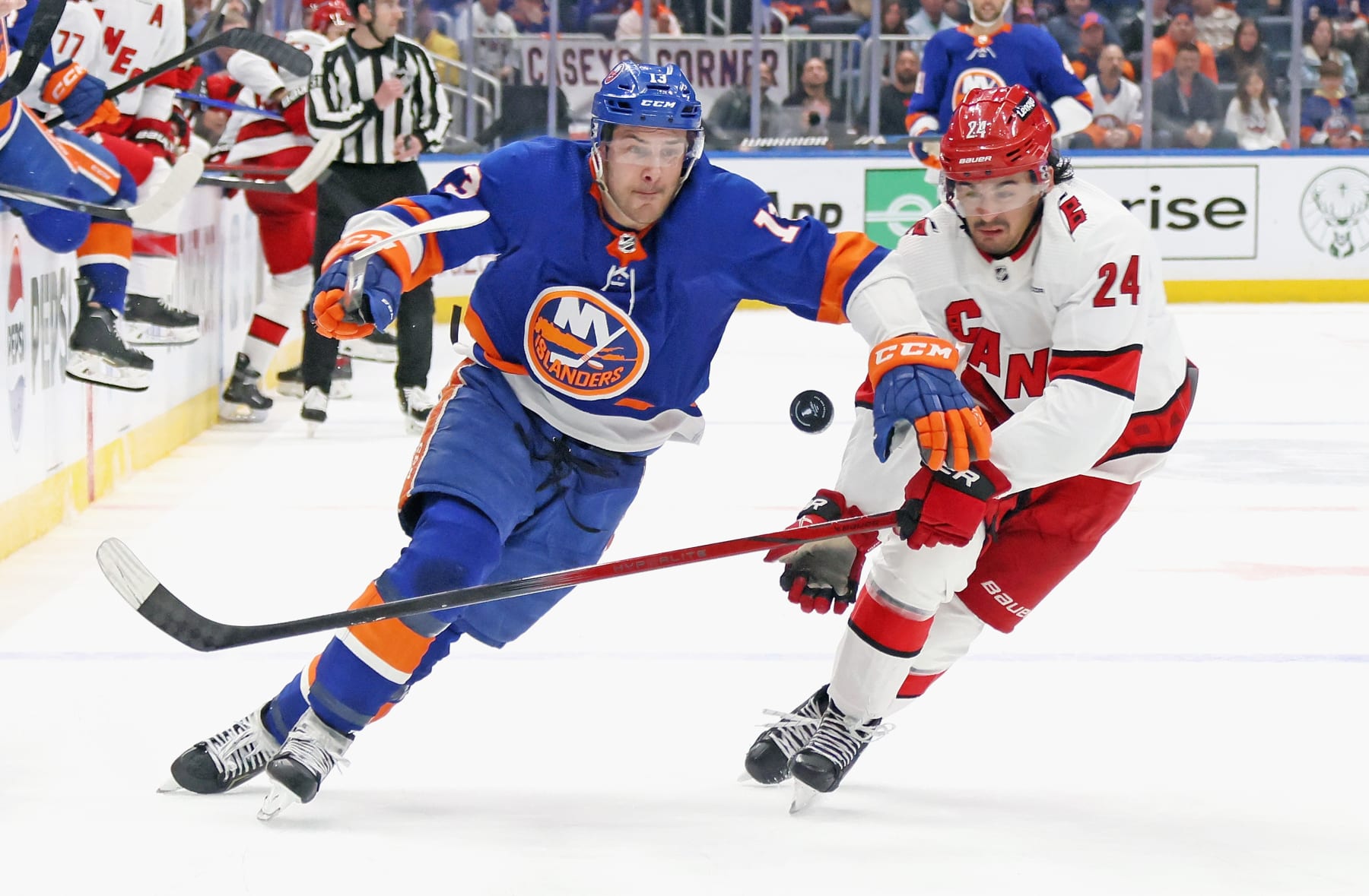 ELMONT, NEW YORK - APRIL 27: Mathew Barzal #13 of the New York Islanders attempts to get past Seth Jarvis #24 of the Carolina Hurricanes during overtime in Game Four of the First Round of the 2024 Stanley Cup Playoffs at UBS Arena on April 27, 2024 in Elmont, New York. (Photo by Bruce Bennett/Getty Images)
