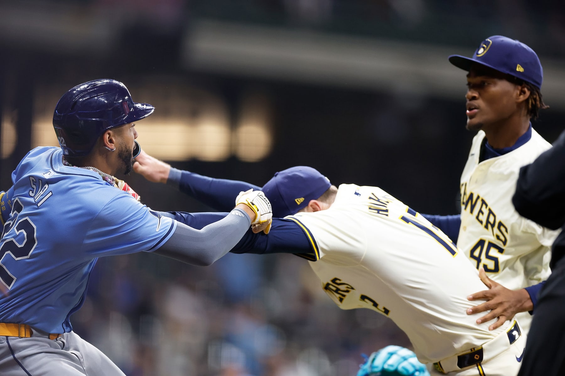 MILWAUKEE, WISCONSIN - APRIL 30: Rhys Hoskins #12 of the Milwaukee Brewers holds back Jose Siri #22 of the Tampa Bay Rays who attempts to go after pitcher Abner Uribe #45 of the Milwaukee Brewers in the eighth inning at American Family Field on April 30, 2024 in Milwaukee, Wisconsin. (Photo by John Fisher/Getty Images)