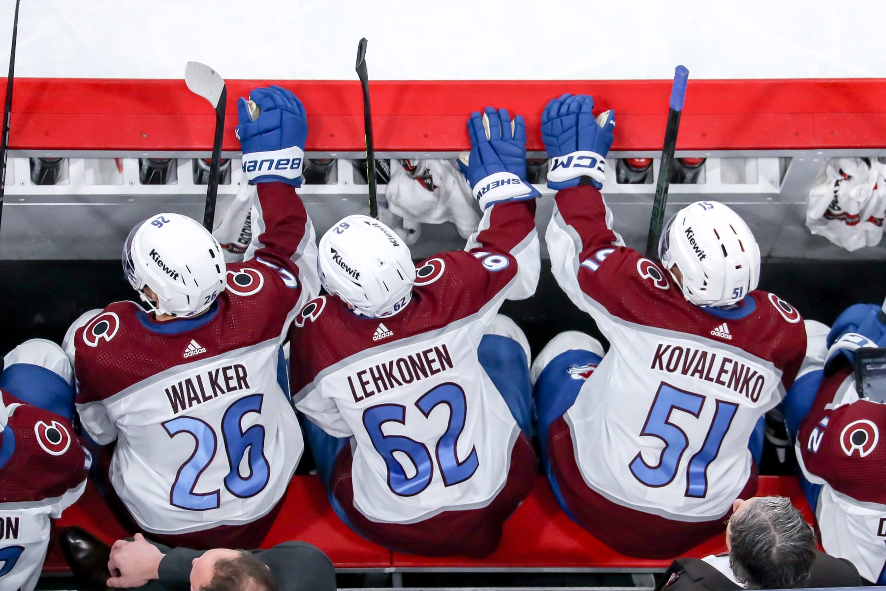 WINNIPEG, CANADA - APRIL 30: Sean Walker #26, Artturi Lehkonen #62 and Nikolai Kovalenko #51 of the Colorado Avalanche look on from the bench during second period action against the Winnipeg Jets in Game Five of the First Round of the 2024 Stanley Cup Playoffs at the Canada Life Centre on April 30, 2024 in Winnipeg, Manitoba, Canada. The Avs defeated the Jets 6-3 and win the series 4-1. (Photo by Darcy Finley/NHLI via Getty Images)