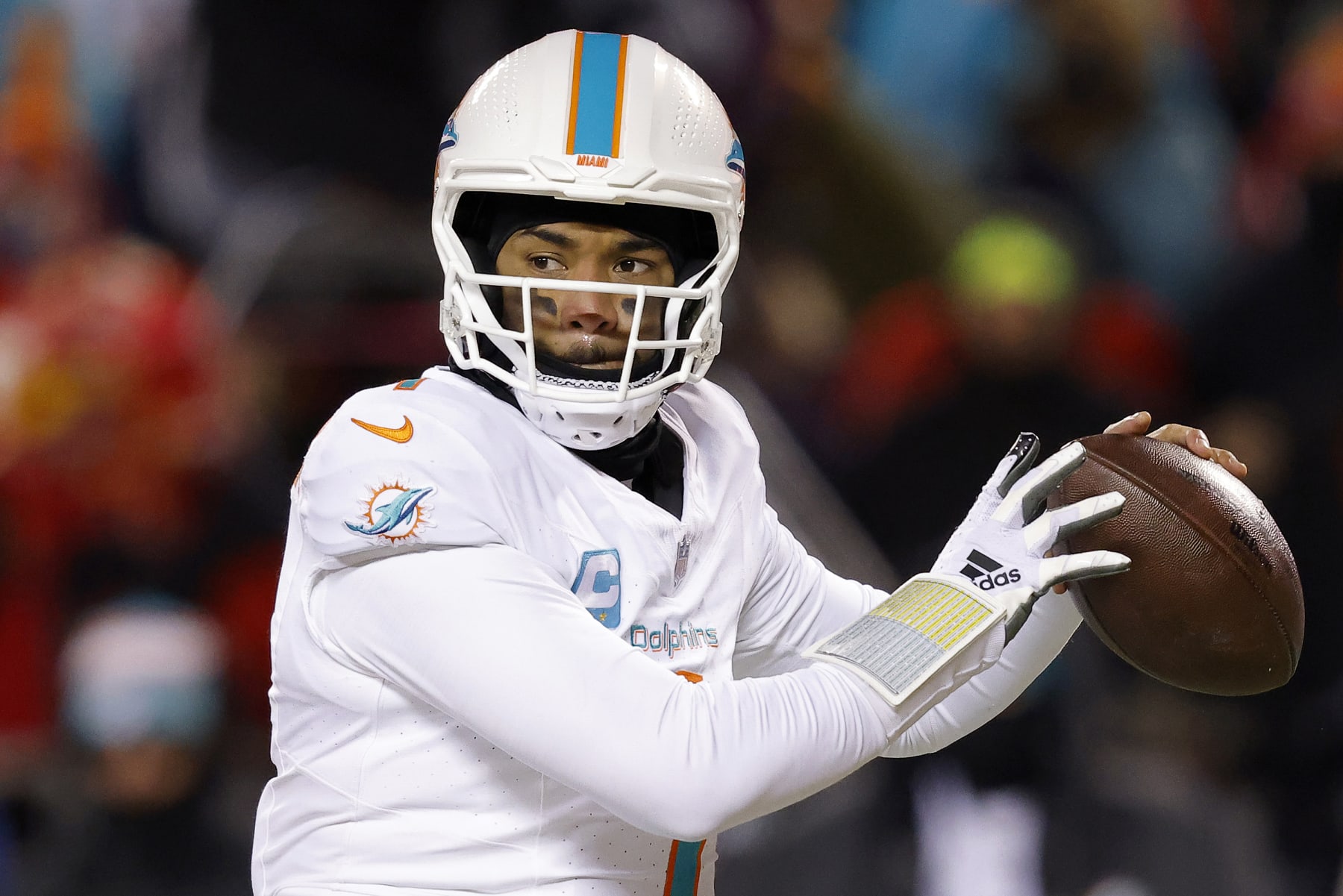 KANSAS CITY, MISSOURI - JANUARY 13: Tua Tagovailoa #1 of the Miami Dolphins looks to pass during the first half against the Kansas City Chiefs in the AFC Wild Card Playoffs at GEHA Field at Arrowhead Stadium on January 13, 2024 in Kansas City, Missouri. (Photo by David Eulitt/Getty Images)