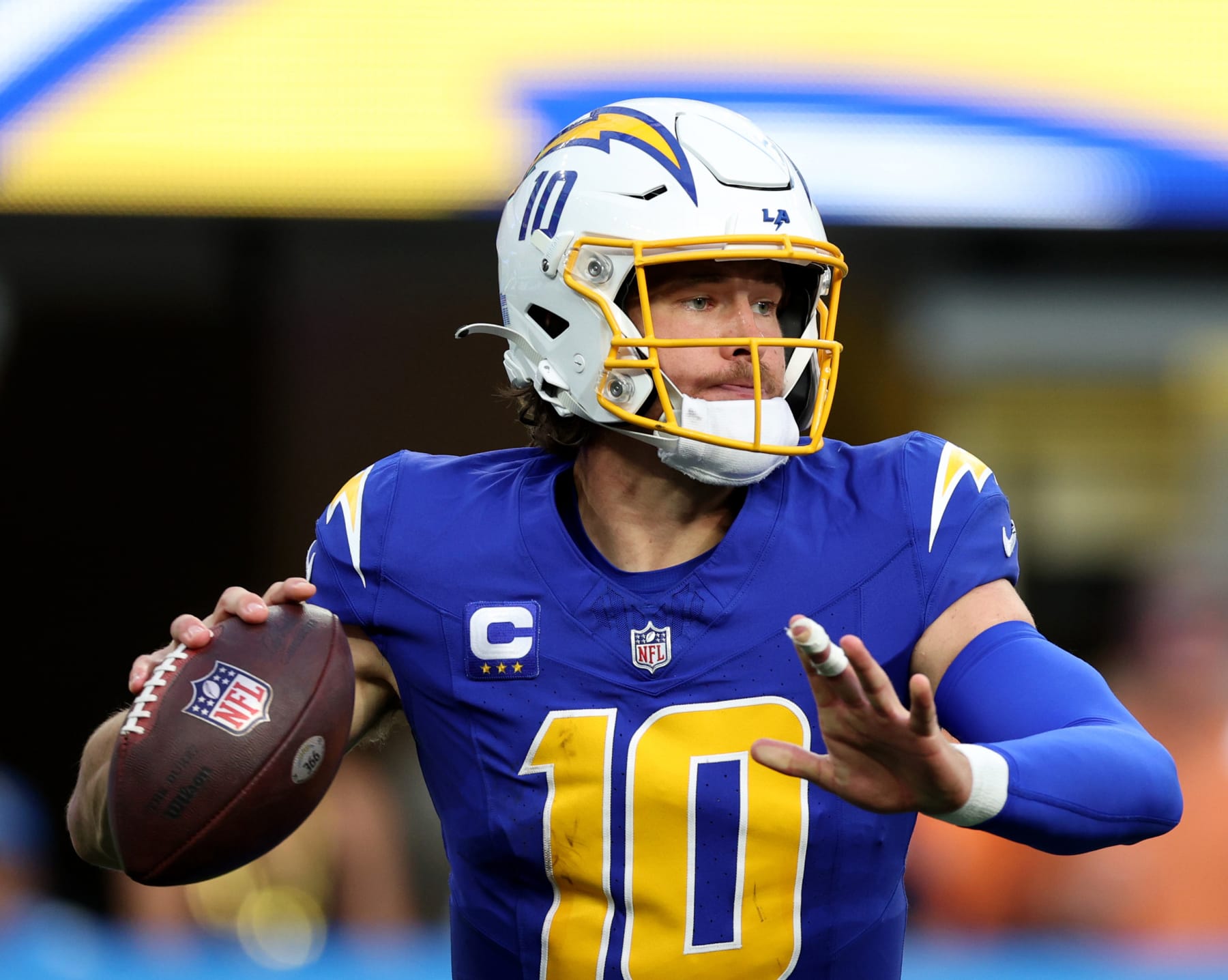 INGLEWOOD, CALIFORNIA - DECEMBER 10: Justin Herbert #10 of the Los Angeles Chargers prepares to pass during a 24-7 loss to the Denver Broncos at SoFi Stadium on December 10, 2023 in Inglewood, California. (Photo by Harry How/Getty Images)