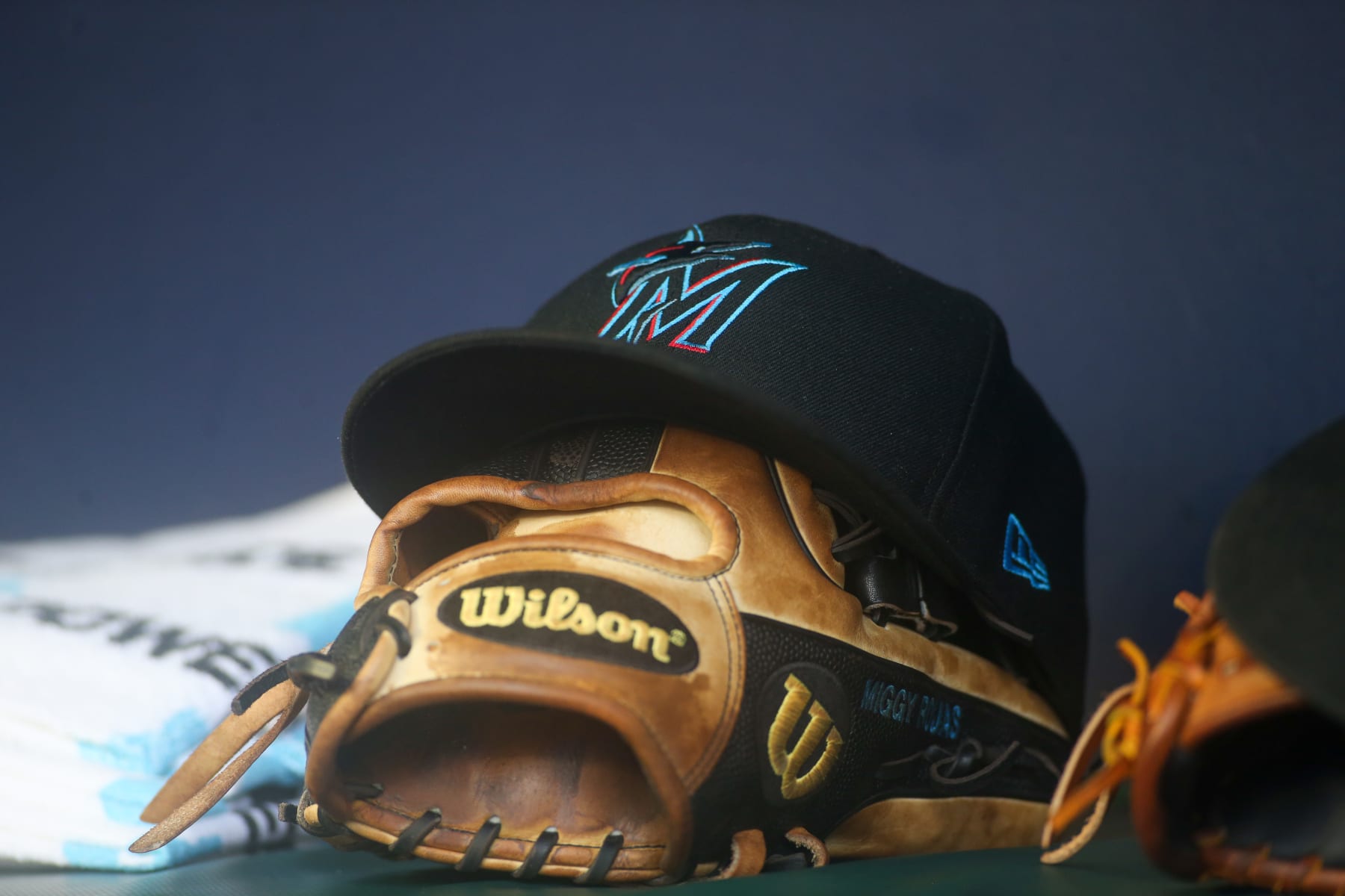 ATLANTA, GA - SEPTEMBER 04: A detailed view of a Miami Marlins hat and glove on the bench against the Atlanta Braves in the seventh inning at Truist Park on September 4, 2022 in Atlanta, Georgia. (Photo by Brett Davis/Getty Images)
