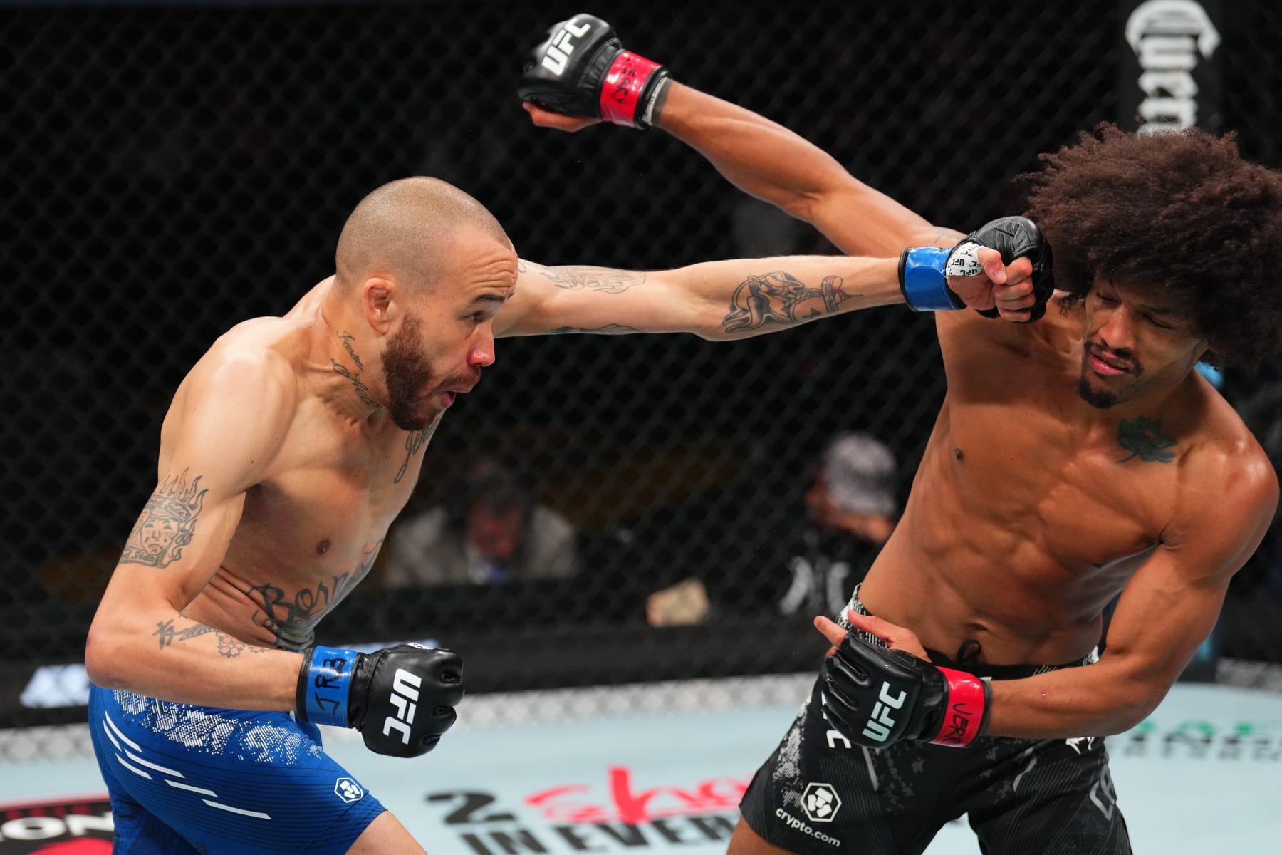 ST LOUIS, MISSOURI - MAY 11: (L-R) Sean Woodson punches Alex Caceres in a featherweight fight during the UFC Fight Night event at Enterprise Center on May 11, 2024 in St Louis, Missouri. (Photo by Josh Hedges/Zuffa LLC via Getty Images)