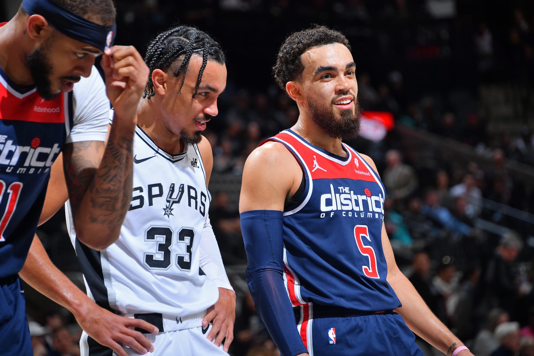 SAN ANTONIO, TX - JANUARY 29: Tyus Jones #5 of the Washington Wizards and Tre Jones #33 of the San Antonio Spurs look on during the game on January 29, 2024 at the Frost Bank Center in San Antonio, Texas. NOTE TO USER: User expressly acknowledges and agrees that, by downloading and or using this photograph, user is consenting to the terms and conditions of the Getty Images License Agreement. Mandatory Copyright Notice: Copyright 2024 NBAE (Photos by Michael Gonzales/NBAE via Getty Images)