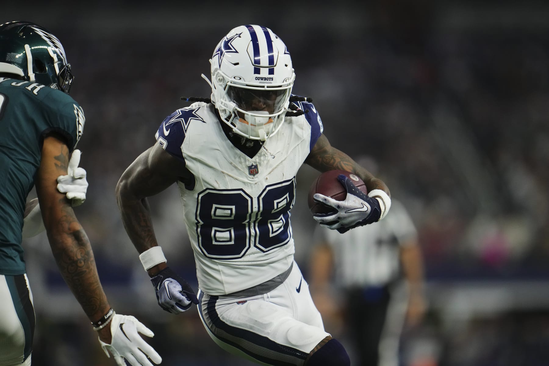 ARLINGTON, TX - DECEMBER 10: CeeDee Lamb #88 of the Dallas Cowboys runs with the ball against the Philadelphia Eagles during the first half at AT&T Stadium on December 10, 2023 in Arlington, Texas. (Photo by Cooper Neill/Getty Images)