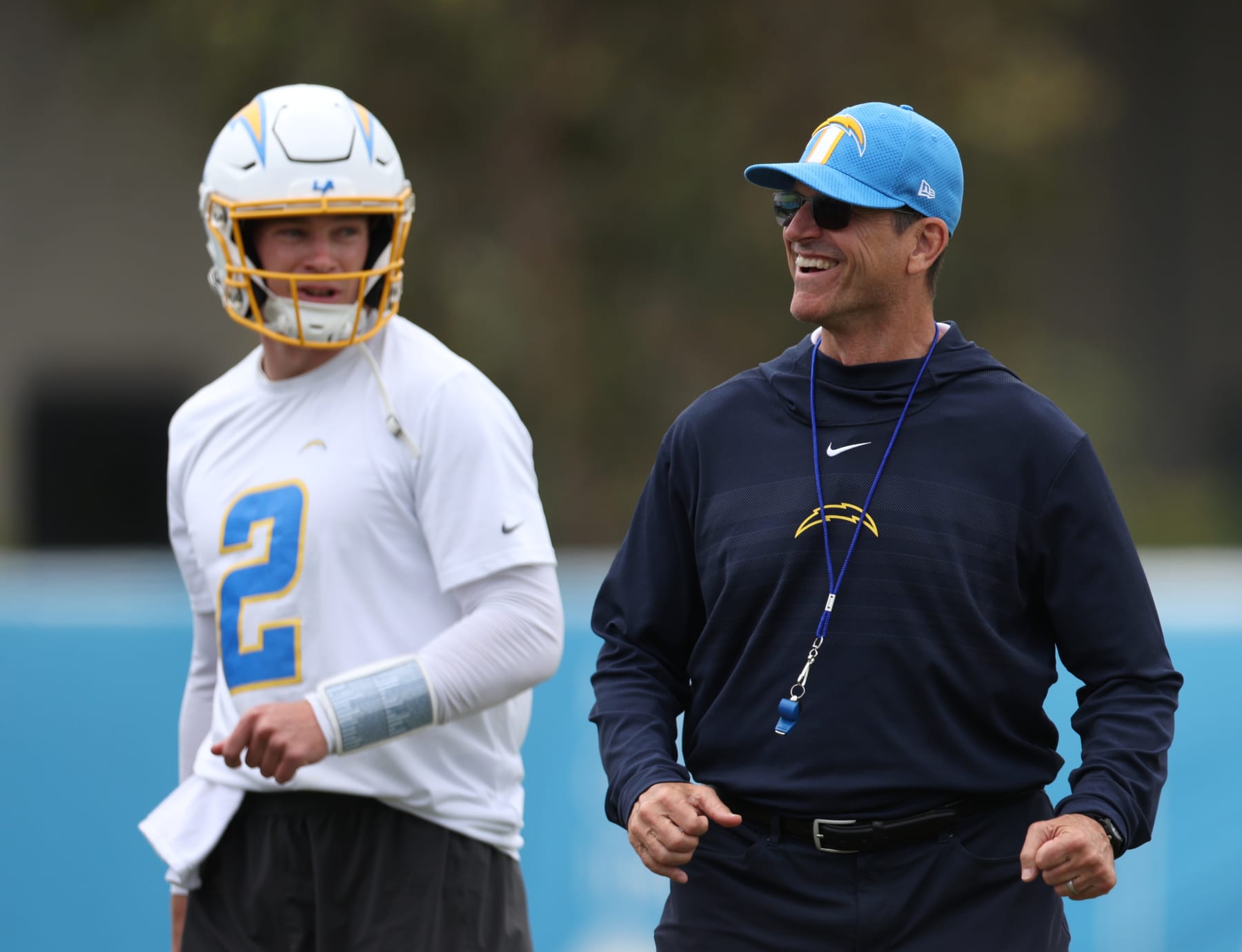 COSTA MESA, CALIFORNIA - MAY 20: Head coach Jim Harbaugh reacts with Easton Stick #2 during a Los Angeles Chargers OTA offseason workout on May 20, 2024 in Costa Mesa, California. (Photo by Harry How/Getty Images)