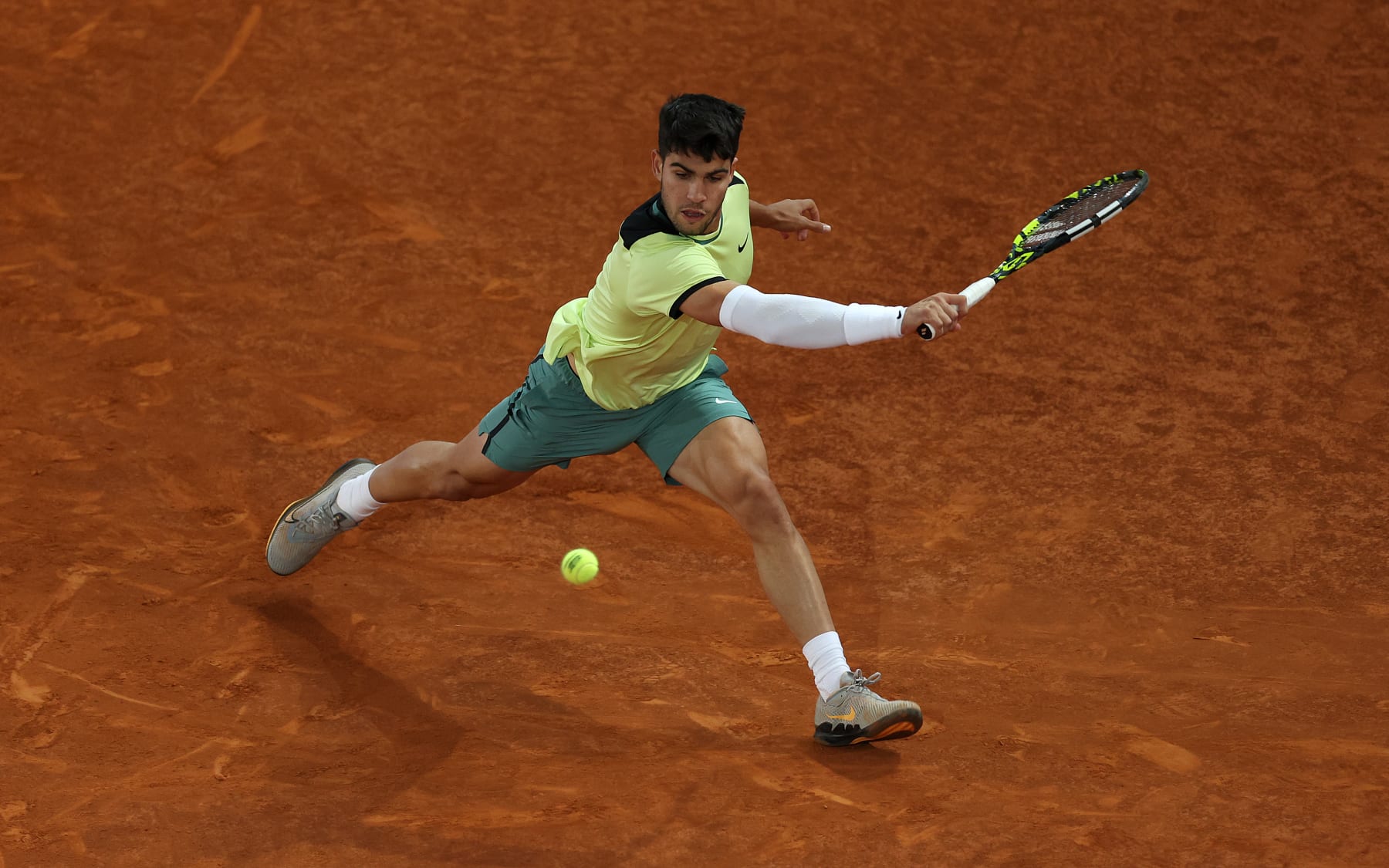 MADRID, SPAIN - MAY 01: Carlos Alcaraz of Spain serves against Andrey Rublev of Russia during their Men’s Singles quarter-final match on Day Nine of the Muta Madrid Open at La Caja Magica on May 01, 2024 in Madrid, Spain. (Photo by Julian Finney/Getty Images)