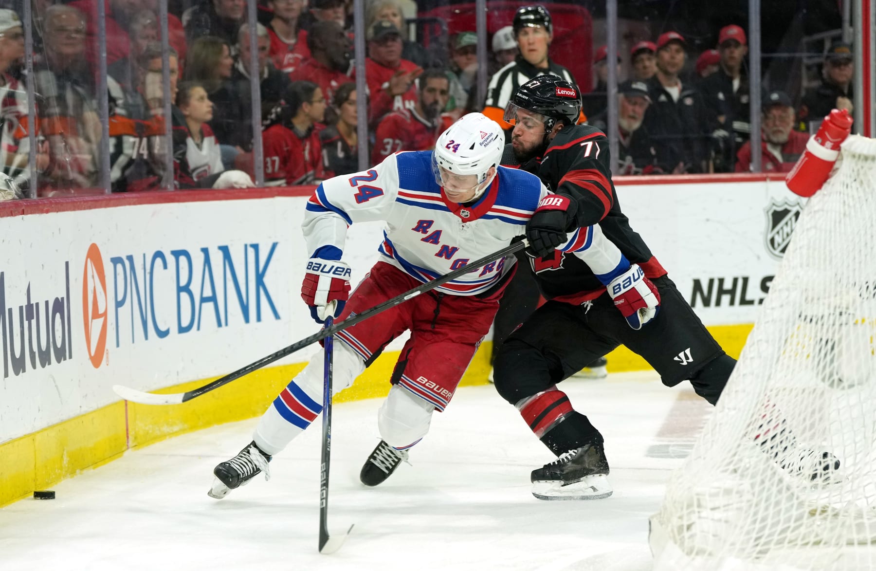RALEIGH, NORTH CAROLINA - MAY 16: Kaapo Kakko #24 of the New York Rangers and Tony DeAngelo #77 of the Carolina Hurricanes battle during the first period in Game Six of the Second Round of the 2024 Stanley Cup Playoffs at PNC Arena on May 16, 2024 in Raleigh, North Carolina. (Photo by Grant Halverson/Getty Images)