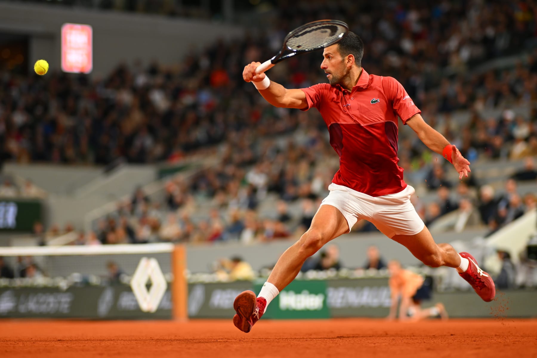 PARIS, FRANCE - MAY 30: Novak Djokovic of Serbia plays a backhand against Roberto Carballes Baena of Spain in the Men's Singles second round match during Day Five of the 2024 French Open at Roland Garros on May 30, 2024 in Paris, France. (Photo by Clive Mason/Getty Images)