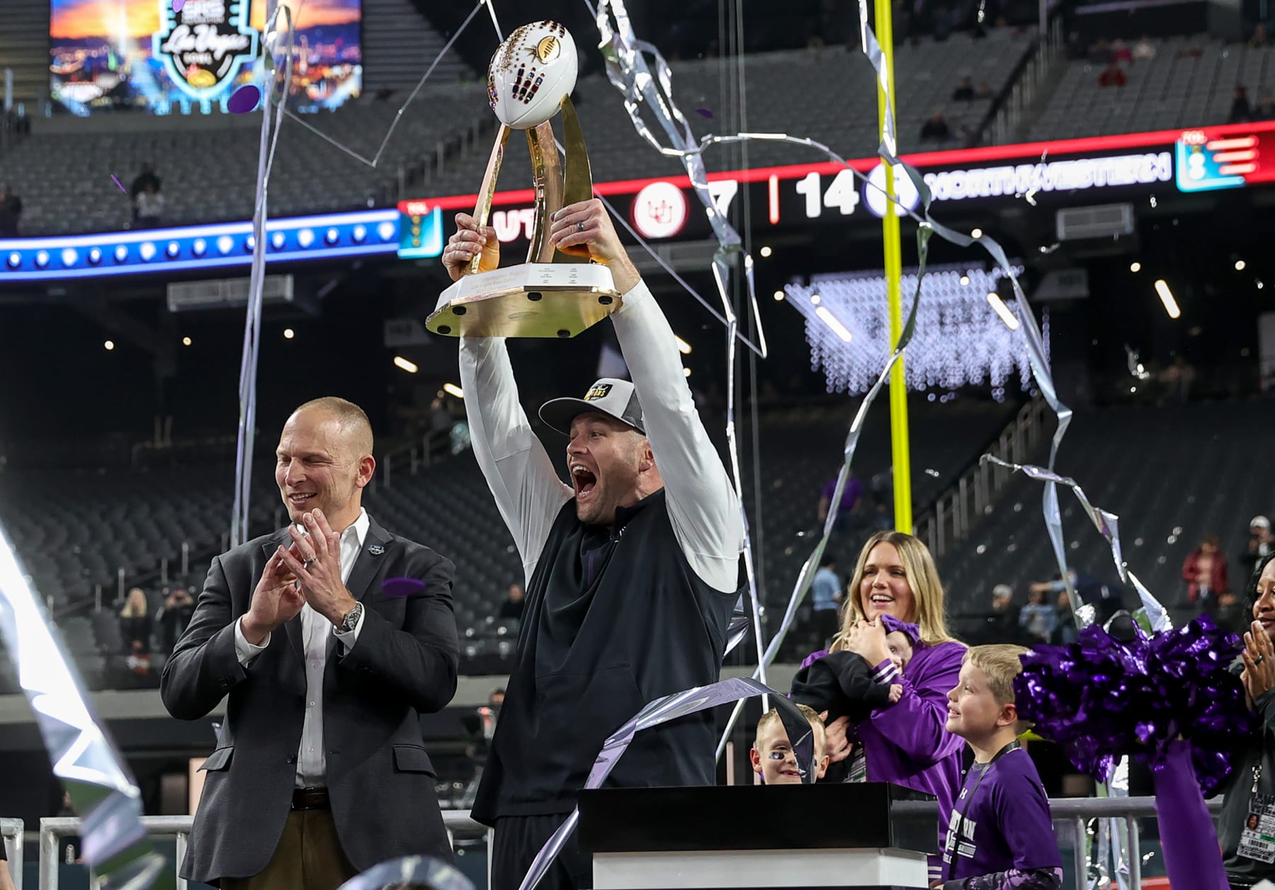 LAS VEGAS, NV - DECEMBER 23: Northwestern Wildcats head coach David Braun holds up the trophy in the SRS Distribution Las Vegas Bowl played between the Utah Utes and the Northwestern Wildcats on December 23, 2023 at Allegiant Stadium in Las Vegas, Nevada. (Photo by Steve Nurenberg/Icon Sportswire via Getty Images)