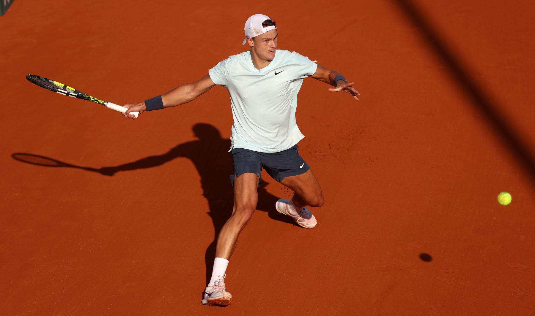 PARIS, FRANCE - MAY 30: Holger Rune of Denmark plays a forehand against Flavio Cobolli of Italy in the Men's Singles second round match during Day Five of the 2024 French Open at Roland Garros on May 30, 2024 in Paris, France. (Photo by Clive Brunskill/Getty Images)