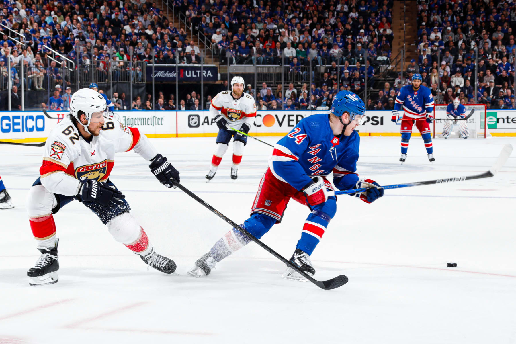 NEW YORK, NEW YORK - MAY 30: Kaapo Kakko #24 of the New York Rangers and Brandon Montour #62 of the Florida Panthers fight for the puck during the first period in Game Five of the Eastern Conference Final of the 2024 Stanley Cup Playoffs at Madison Square Garden on May 30, 2024 in New York City. (Photo by Jared Silber/NHLI via Getty Images)