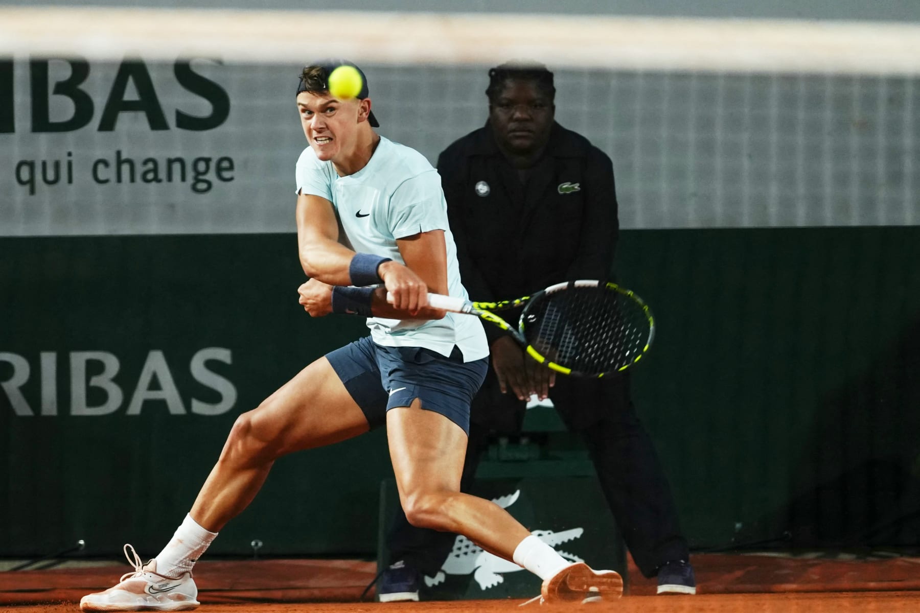 Denmark's Holger Rune plays a forehand return to Slovakia's Jozef Kovalik on Court Simonne-Mathieu during their men's singles match on day seven of the French Open tennis tournament at the Roland Garros Complex in Paris on June 1, 2024. (Photo by Dimitar DILKOFF / AFP) (Photo by DIMITAR DILKOFF/AFP via Getty Images)