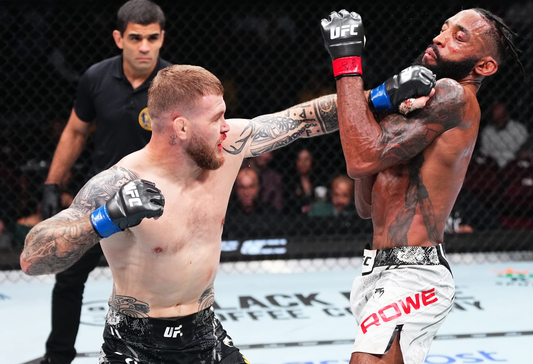 NEWARK, NEW JERSEY - JUNE 01: (L-R) Jake Matthews of Australia punches Phil Rowe in a welterweight fight during the UFC 302 event at Prudential Center on June 01, 2024 in Newark, New Jersey. (Photo by Jeff Bottari/Zuffa LLC via Getty Images)