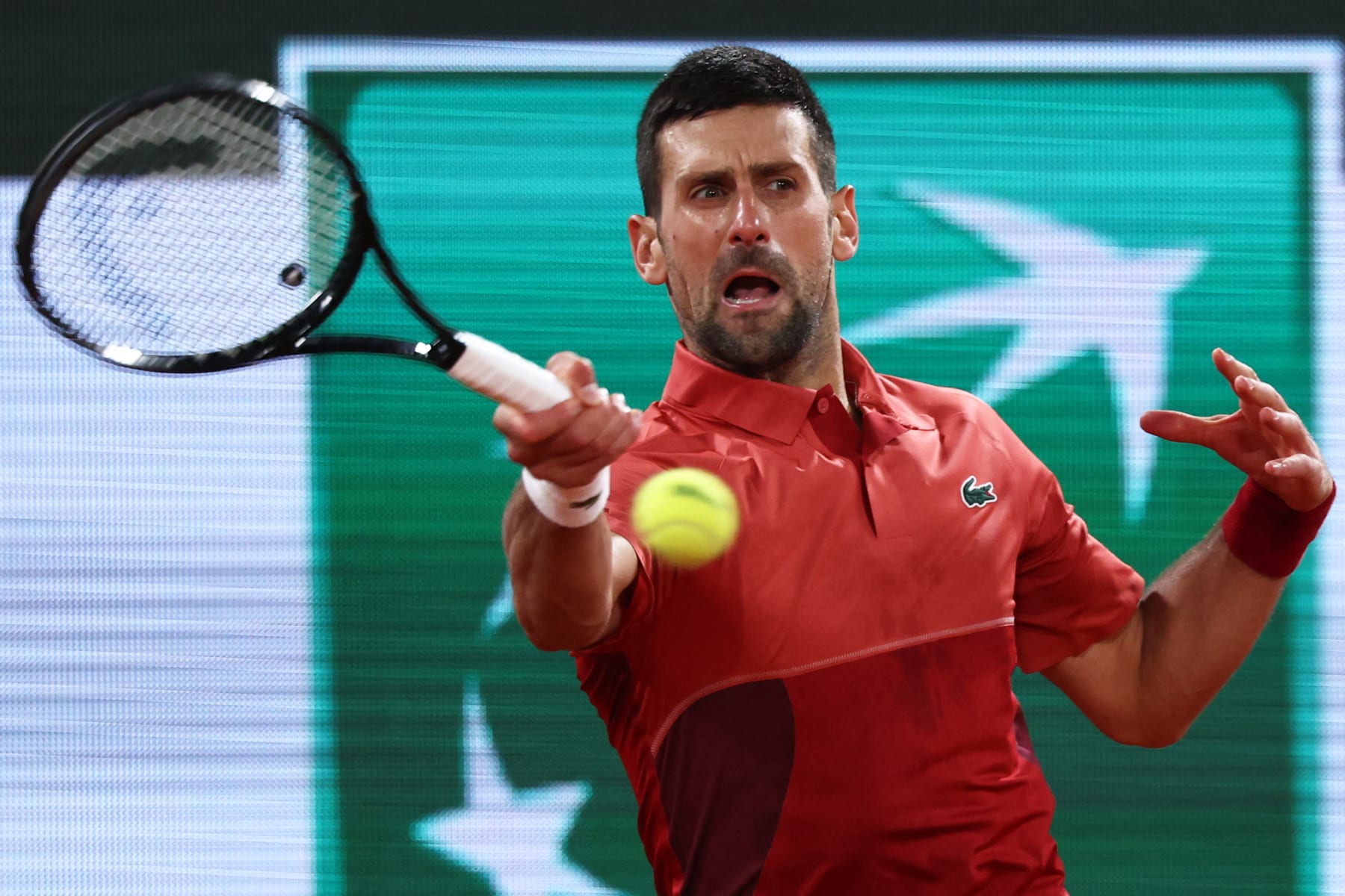 Serbia's Novak Djokovic plays a forehand return to Italy's Lorenzo Musetti during their men's singles match on Court Philippe-Chatrier on day seven of the French Open tennis tournament at the Roland Garros Complex in Paris on June 1, 2024. (Photo by EMMANUEL DUNAND / AFP) (Photo by EMMANUEL DUNAND/AFP via Getty Images)