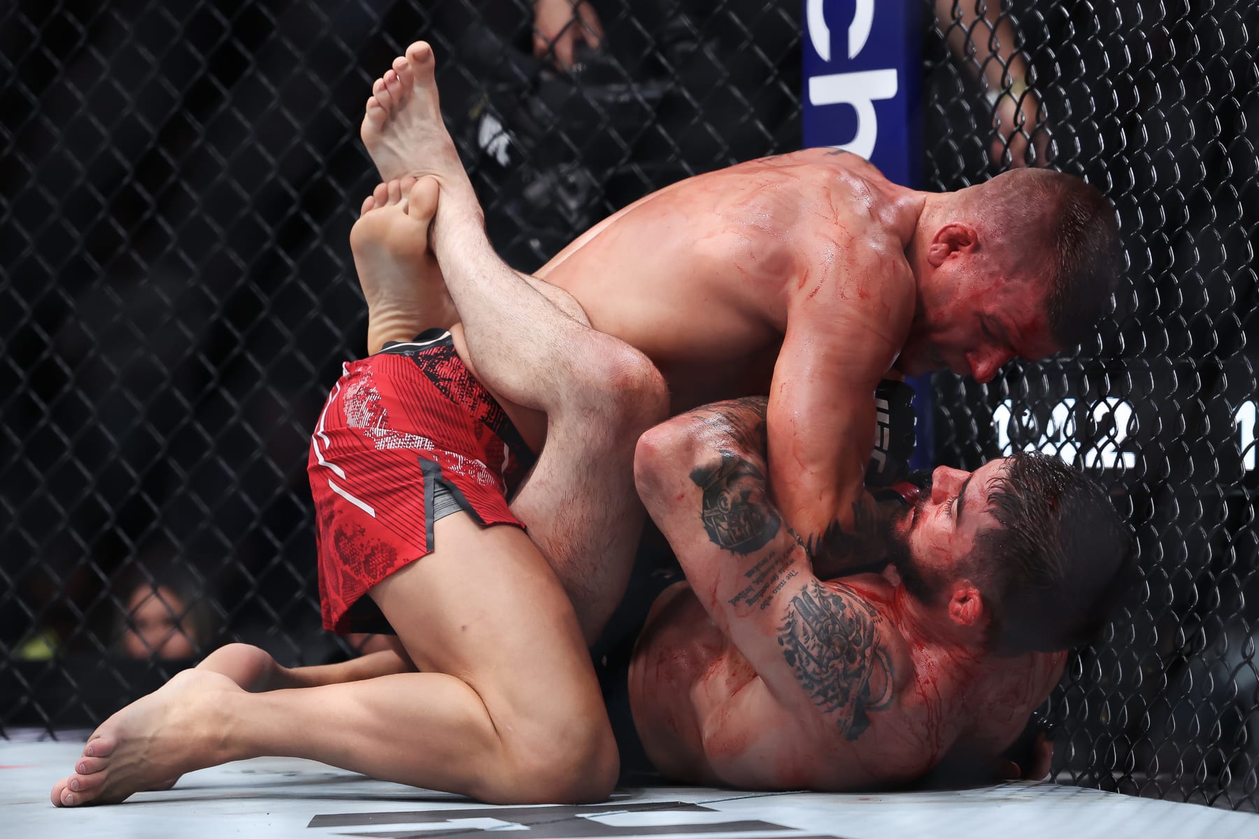 NEWARK, NEW JERSEY - JUNE 01: Grant Dawson (red) grapples with Joe Solecki (blue) in their lightweight bout during UFC 302 at Prudential Center on June 01, 2024 in Newark, New Jersey. (Photo by Luke Hales/Getty Images)