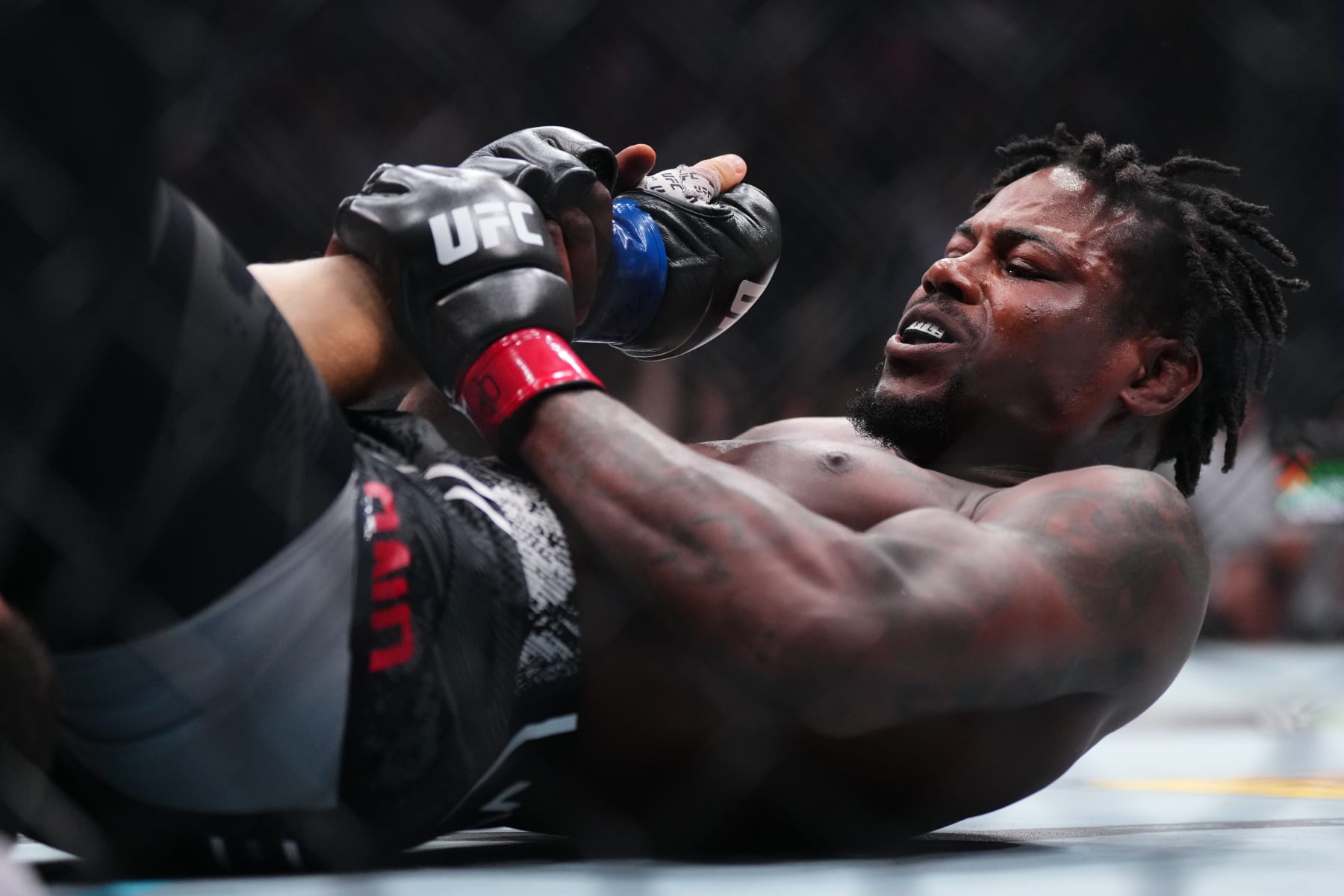 NEWARK, NEW JERSEY - JUNE 01: Kevin Holland secures an arm bar submission against Michal Oleksiejczuk of Poland in a middleweight fight during the UFC 302 event at Prudential Center on June 01, 2024 in Newark, New Jersey. (Photo by Cooper Neill/Zuffa LLC via Getty Images)