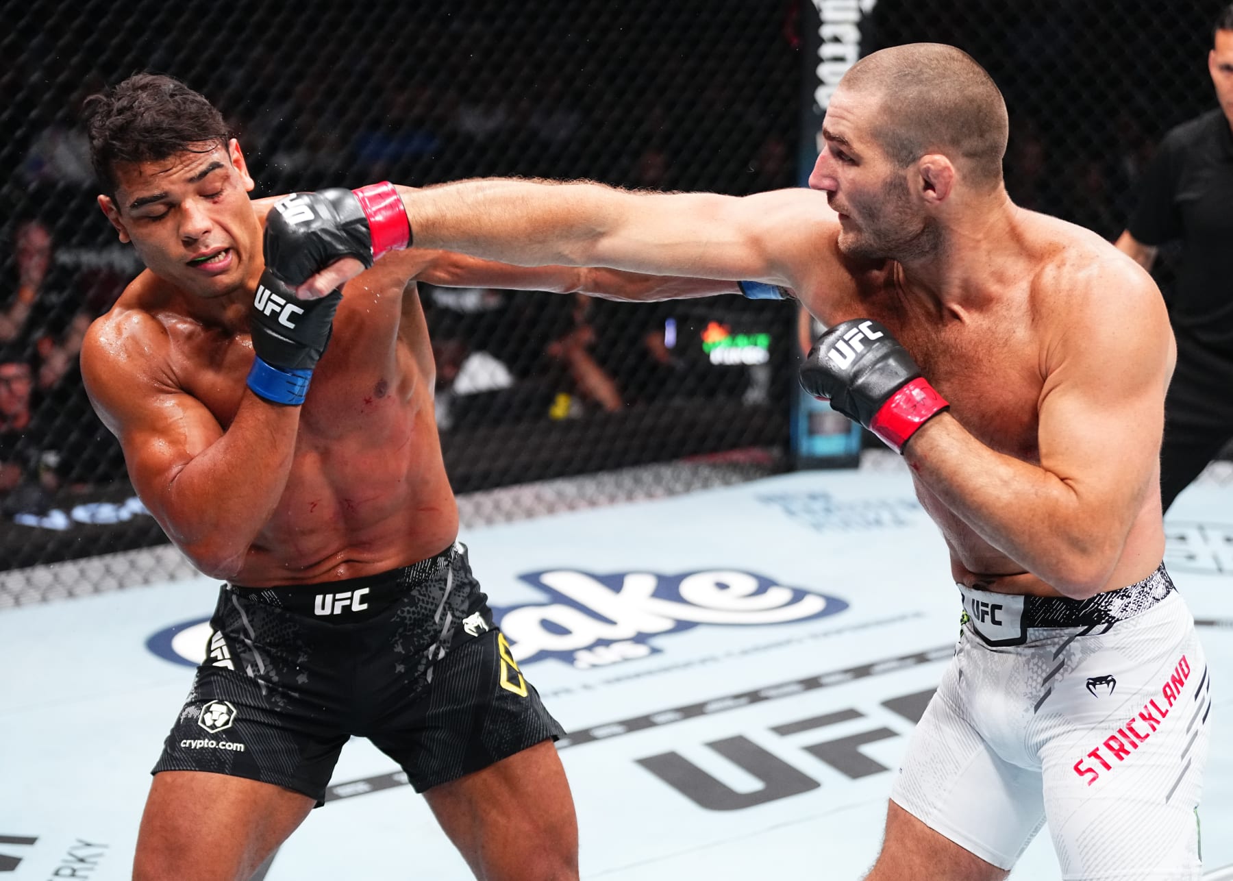 NEWARK, NEW JERSEY - JUNE 01: (R-L) Sean Strickland punches Paulo Costa of Brazil in a middleweight fight during the UFC 302 event at Prudential Center on June 01, 2024 in Newark, New Jersey. (Photo by Jeff Bottari/Zuffa LLC via Getty Images)