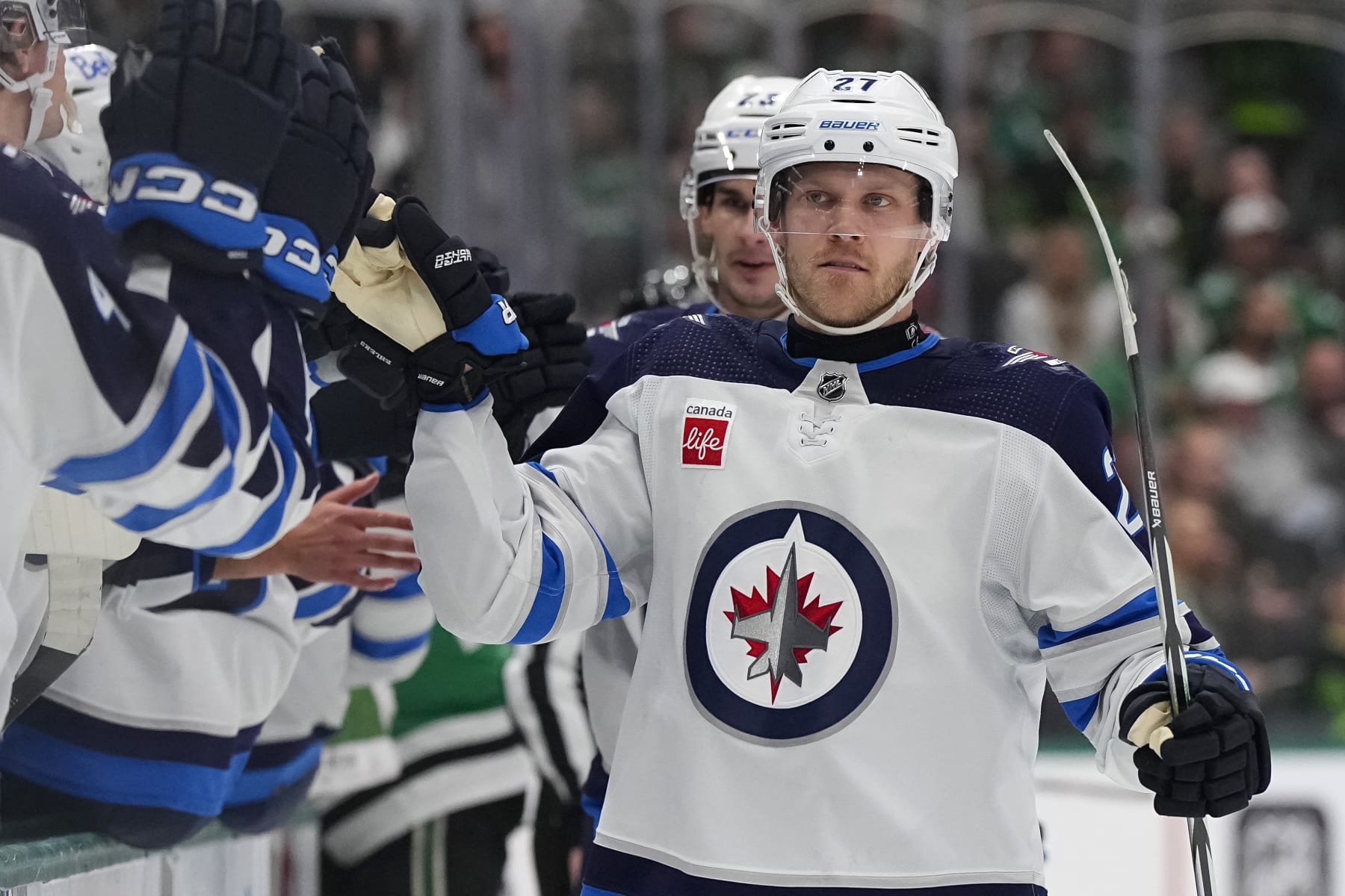DALLAS, TEXAS - APRIL 11: Nikolaj Ehlers #27 of the Winnipeg Jets congratulated by his bench after scoring a goal during the first period against the Dallas Stars at American Airlines Center on April 11, 2024 in Dallas, Texas. (Photo by Sam Hodde/Getty Images)