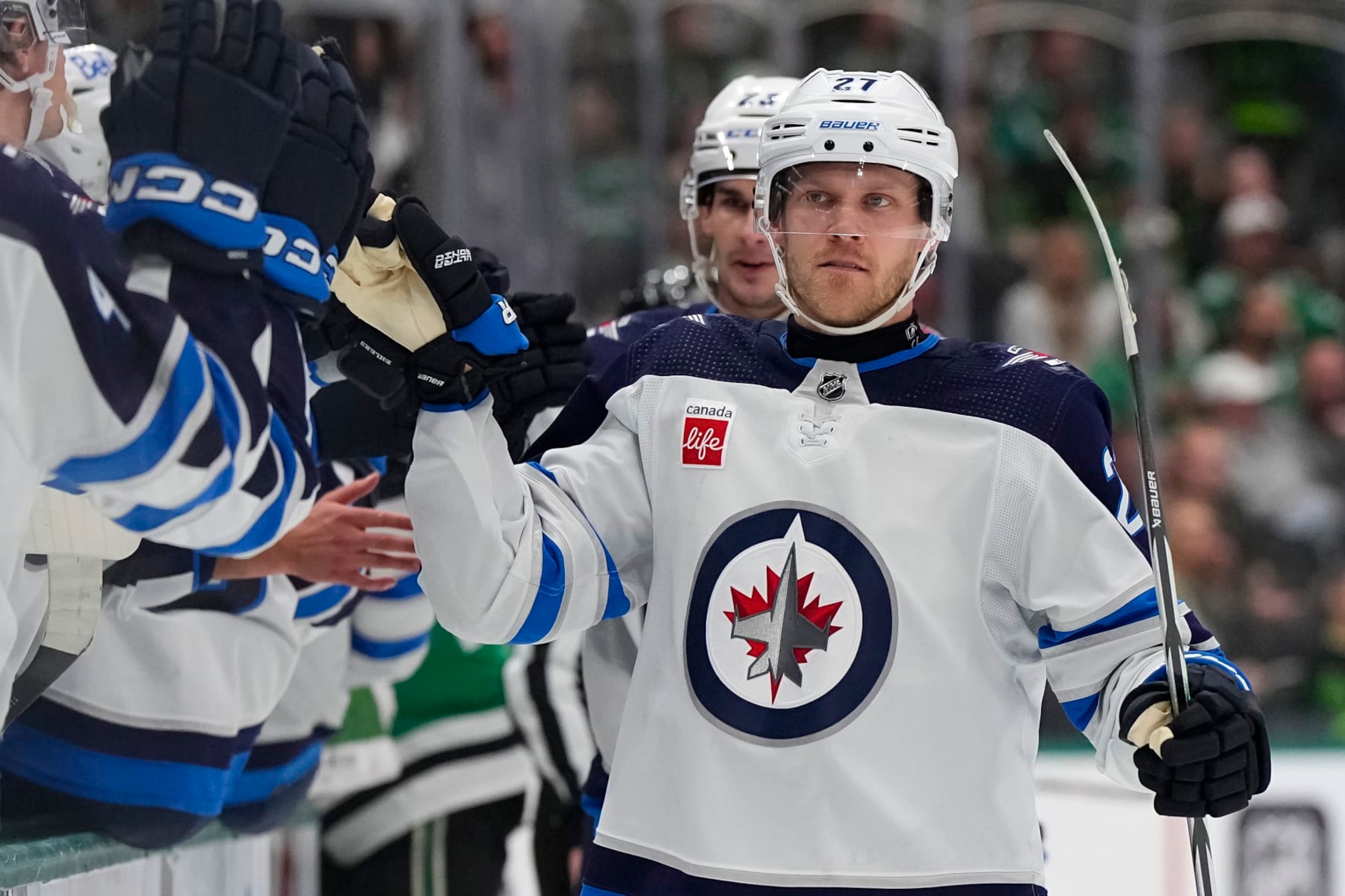 DALLAS, TEXAS - APRIL 11: Nikolaj Ehlers #27 of the Winnipeg Jets congratulated by his bench after scoring a goal during the first period against the Dallas Stars at American Airlines Center on April 11, 2024 in Dallas, Texas. (Photo by Sam Hodde/Getty Images)