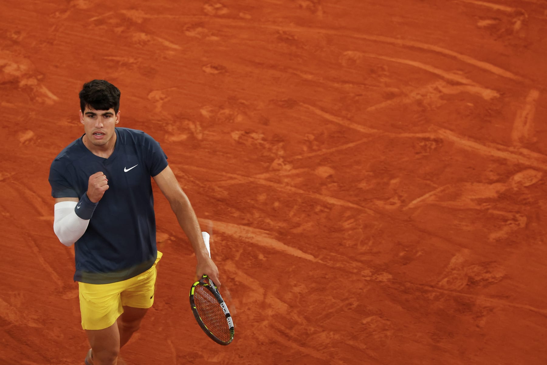 Spain's Carlos Alcaraz Garfia celebrates after a point as he plays against Greece's Stefanos Tsitsipas during their men's singles quarter final match on Court Philippe-Chatrier on day ten of the French Open tennis tournament at the Roland Garros Complex in Paris on June 4, 2024. (Photo by Emmanuel Dunand / AFP) (Photo by EMMANUEL DUNAND/AFP via Getty Images)