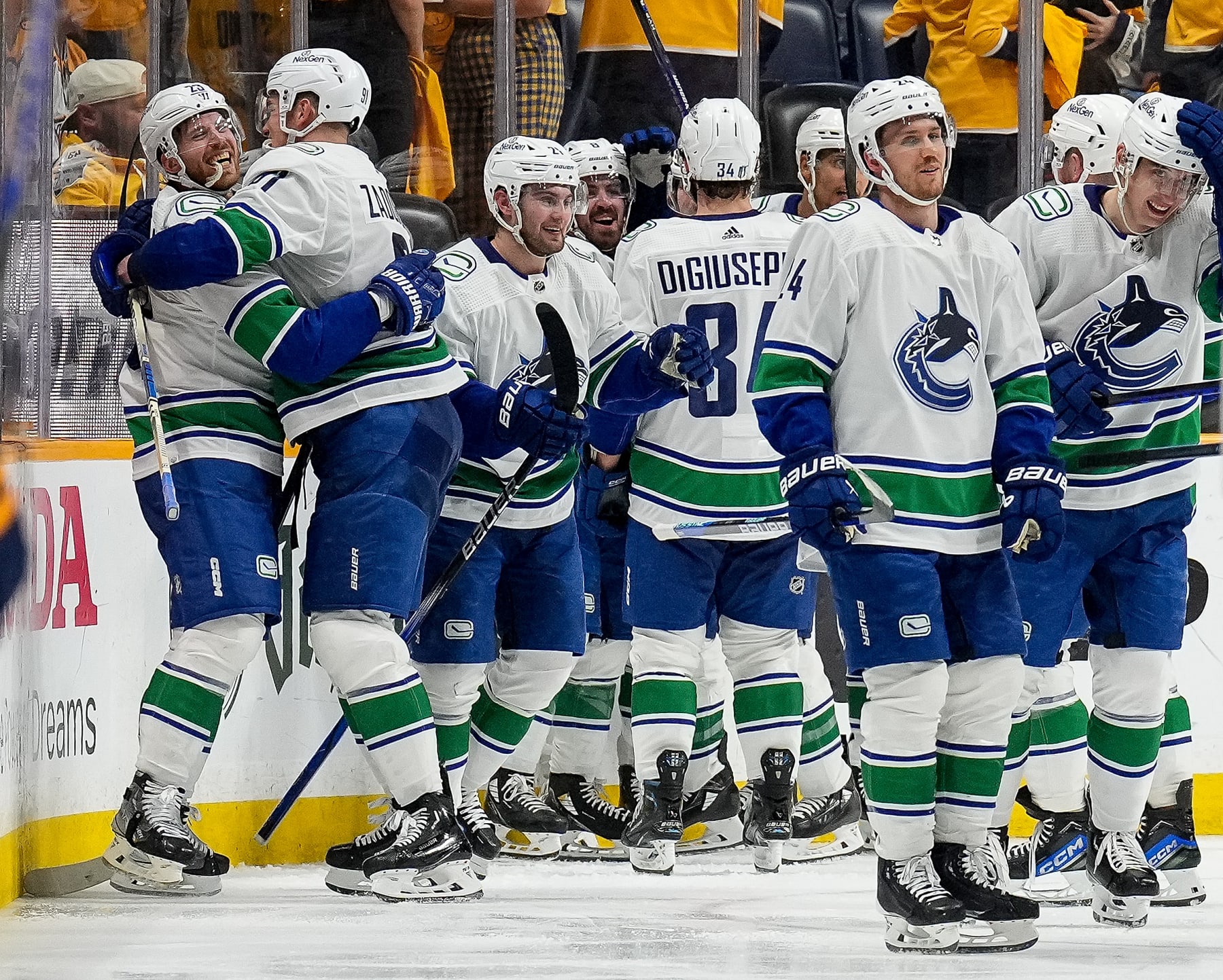 NASHVILLE, TENNESSEE - APRIL 28: Elias Lindholm #23 celebrates his overtime game winning goal with Nikita Zadorov #91 of the Vancouver Canucks against the Nashville Predators in Game Four of the First Round of the 2024 Stanley Cup Playoffs at Bridgestone Arena on April 28, 2024 in Nashville, Tennessee. (Photo by John Russell/NHLI via Getty Images)