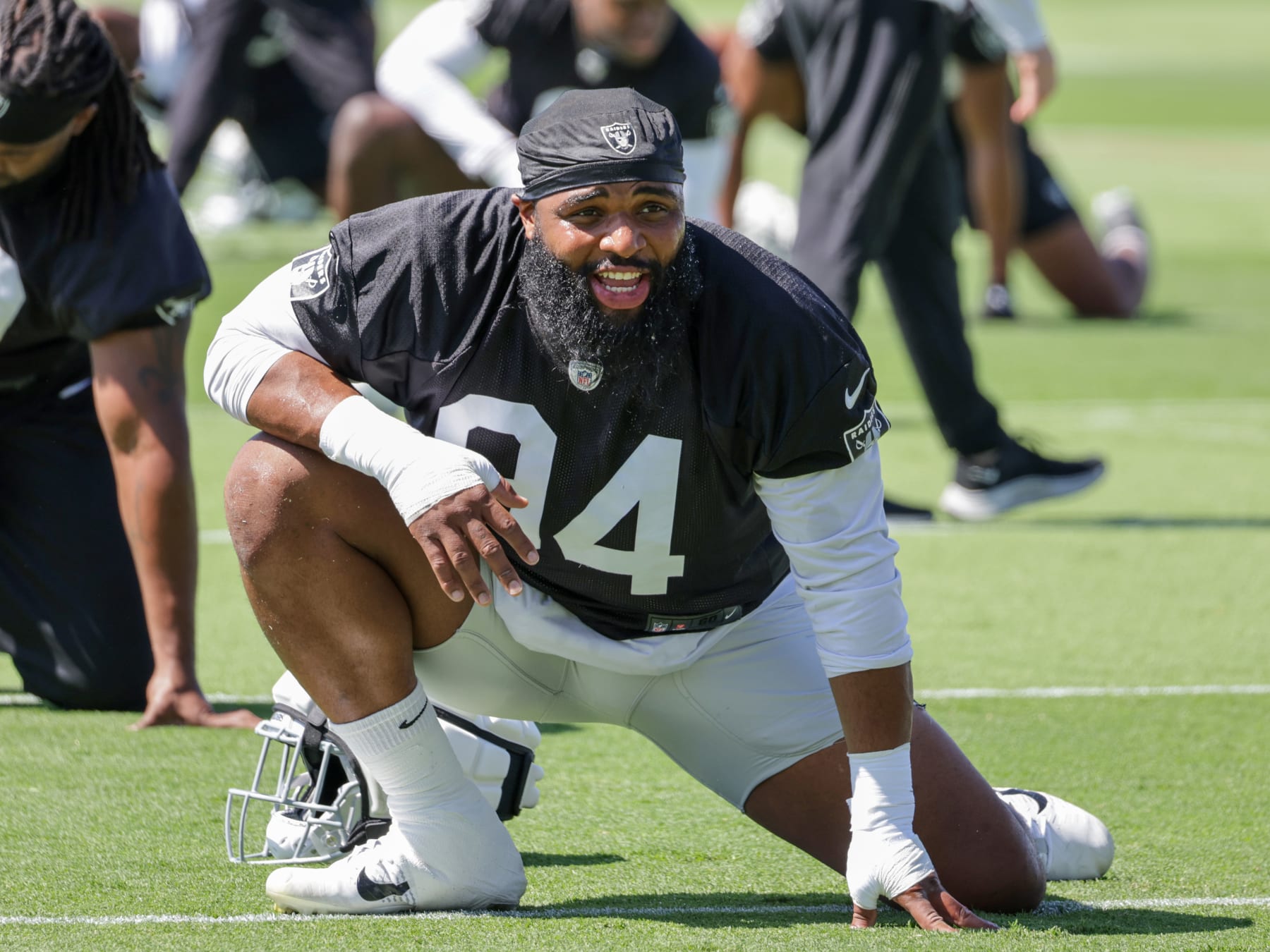 HENDERSON, NEVADA - MAY 29: Defensive tackle Christian Wilkins #94 of the Las Vegas Raiders stretches during an OTA offseason workout at the Las Vegas Raiders Headquarters/Intermountain Healthcare Performance Center on May 29, 2024 in Henderson, Nevada. (Photo by Ethan Miller/Getty Images)