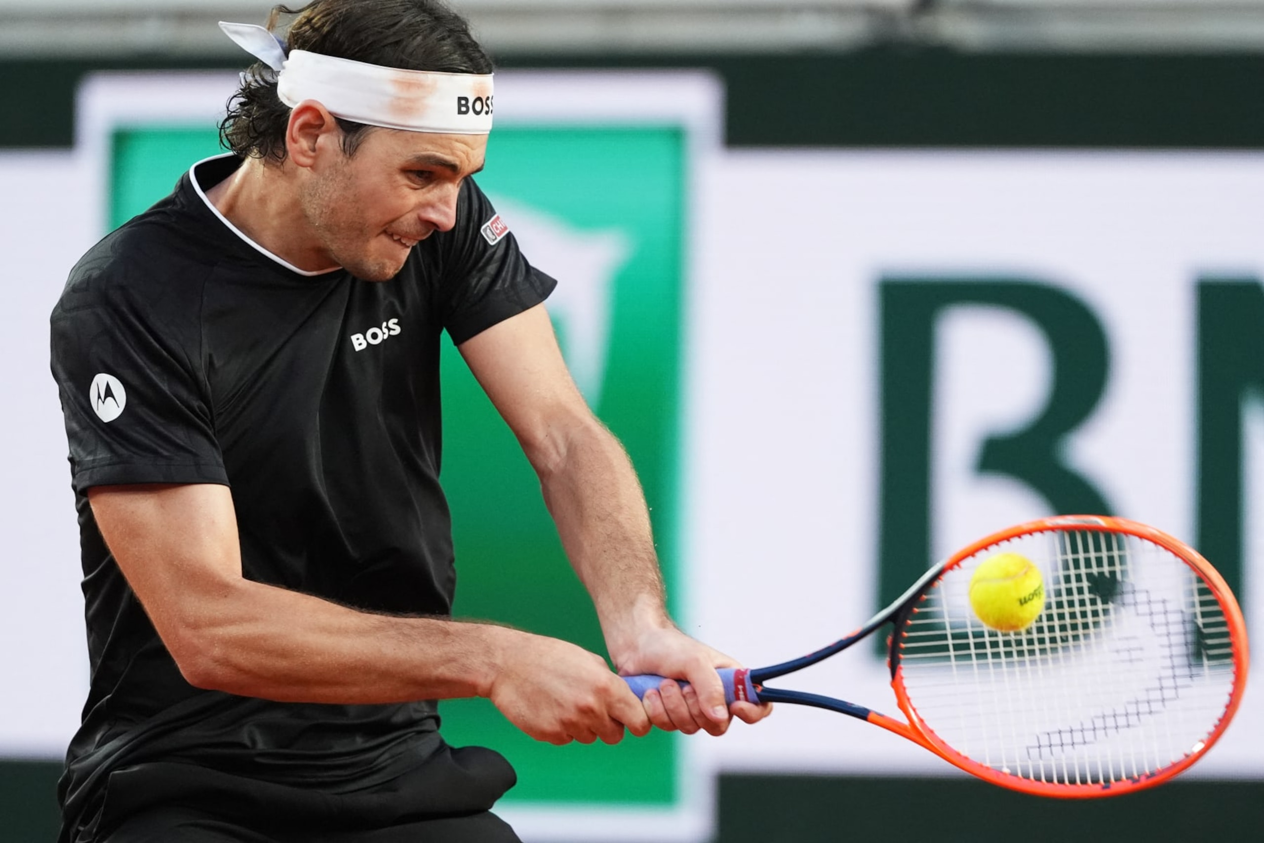 US Taylor Fritz plays a backhand return to Norway's Casper Ruud during their men's singles round of sixteen match on Court Suzanne-Lenglen on day nine of the French Open tennis tournament at the Roland Garros Complex in Paris on June 3, 2024. (Photo by Dimitar DILKOFF / AFP) (Photo by DIMITAR DILKOFF/AFP via Getty Images)