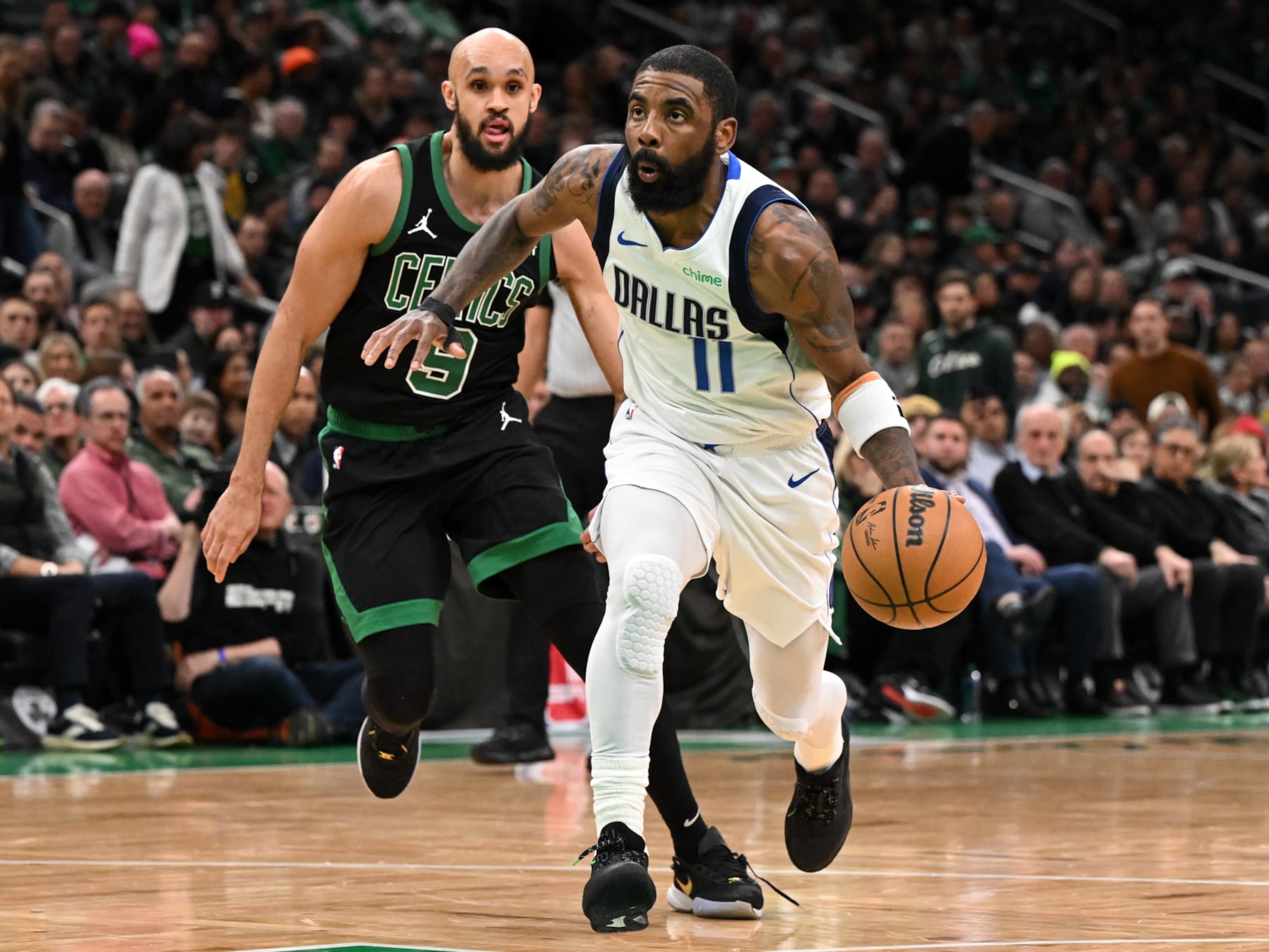 BOSTON, MASSACHUSETTS - MARCH 01: Kyrie Irving #11 of the Dallas Mavericks drives to the basket in front of Derrick White #9 of the Boston Celtics during the second quarter at the TD Garden on March 01, 2024 in Boston, Massachusetts. NOTE TO USER: User expressly acknowledges and agrees that, by downloading and or using this photograph, User is consenting to the terms and conditions of the Getty Images License Agreement. (Photo by Brian Fluharty/Getty Images)