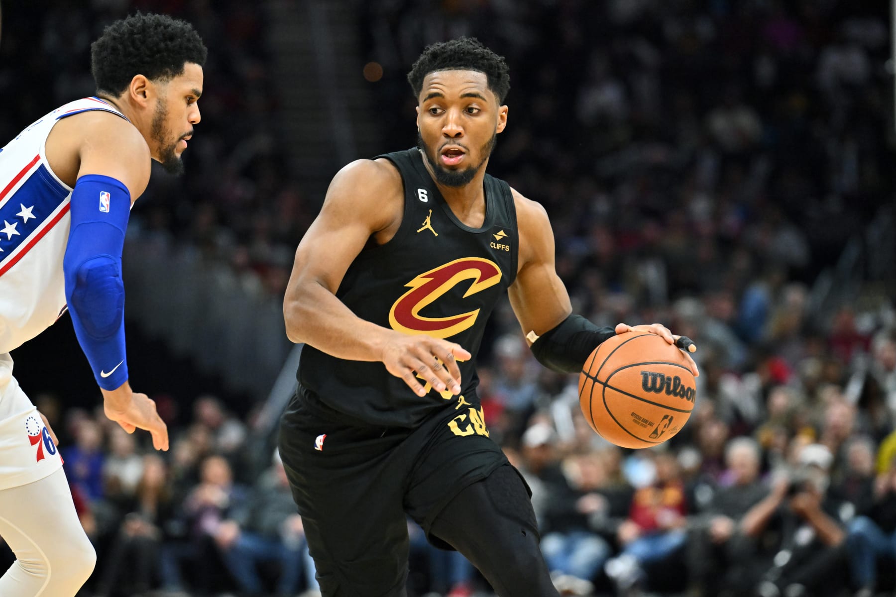 CLEVELAND, OHIO - MARCH 15: Donovan Mitchell #45 of the Cleveland Cavaliers drives around Tobias Harris #12 of the Philadelphia 76ers during the third quarter of the game at Rocket Mortgage Fieldhouse on March 15, 2023 in Cleveland, Ohio. The 76ers defeated the Cavaliers 118-109. NOTE TO USER: User expressly acknowledges and agrees that, by downloading and or using this photograph, User is consenting to the terms and conditions of the Getty Images License Agreement. (Photo by Jason Miller/Getty Images)
