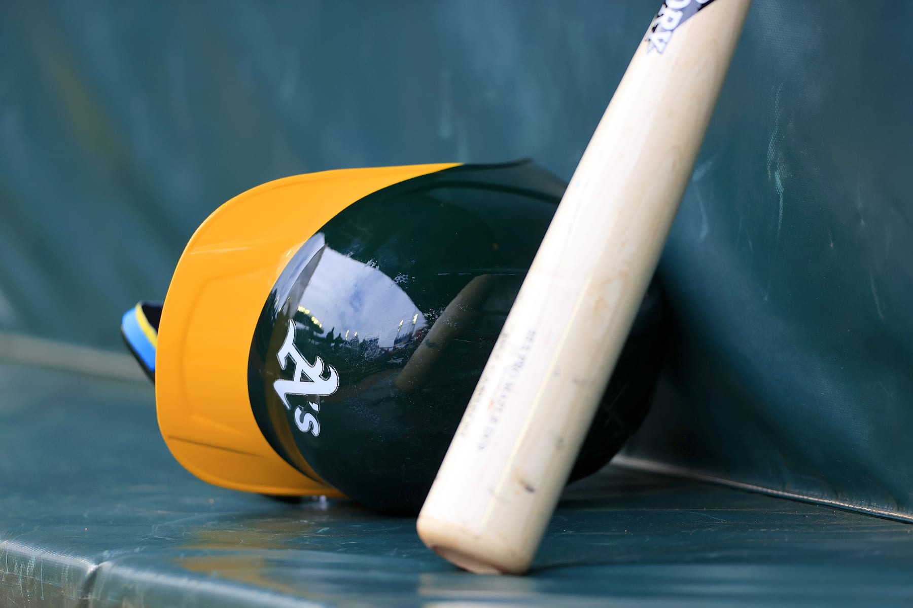 ATLANTA, GA - JUNE 01: An Oakland A's batting helmet and bat in the dugout during the Saturday afternoon MLB game between the Atlanta Braves and the Oakland A's on June 1, 2024 at Truist Park in Atlanta, Georgia.  (Photo by David J. Griffin/Icon Sportswire via Getty Images)