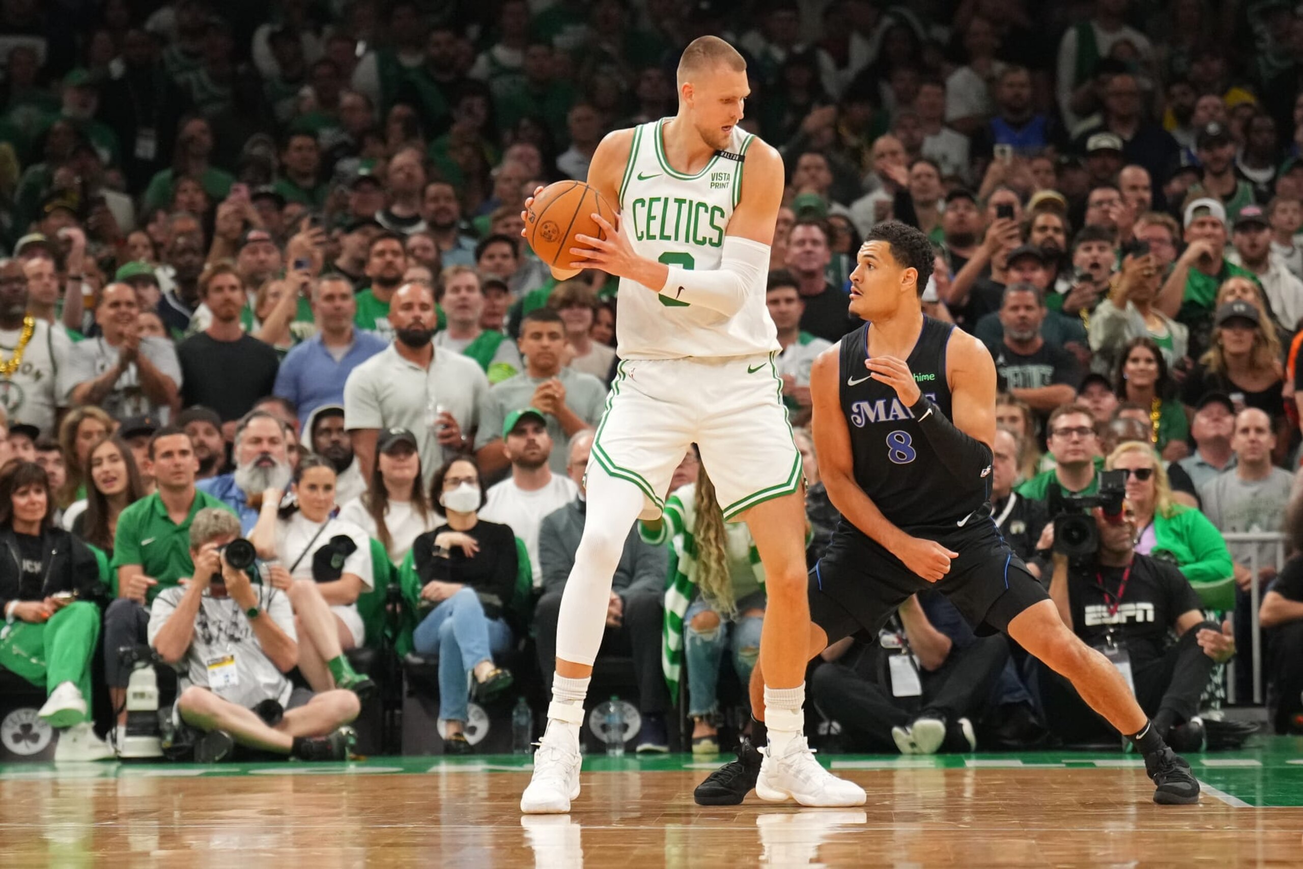 BOSTON, MA - JUNE 6: Kristaps Porzingis #8 of the Boston Celtics handles the ball during the game against the Dallas Mavericks during Game 1 of the 2024 NBA Finals on June 6, 2024 at the TD Garden in Boston, Massachusetts. NOTE TO USER: User expressly acknowledges and agrees that, by downloading and or using this photograph, User is consenting to the terms and conditions of the Getty Images License Agreement. Mandatory Copyright Notice: Copyright 2024 NBAE (Photo by Jesse D. Garrabrant/NBAE via Getty Images) BOSTON, MA - JUNE 6: Kristaps Porzingis #8 of the Boston Celtics handles the ball during the game against the Dallas Mavericks during Game 1 of the 2024 NBA Finals on June 6, 2024 at the TD Garden in Boston, Massachusetts. NOTE TO USER: User expressly acknowledges and agrees that, by downloading and or using this photograph, User is consenting to the terms and conditions of the Getty Images License Agreement. Mandatory Copyright Notice: Copyright 2024 NBAE (Photo by Jesse D. Garrabrant/NBAE via Getty Images)