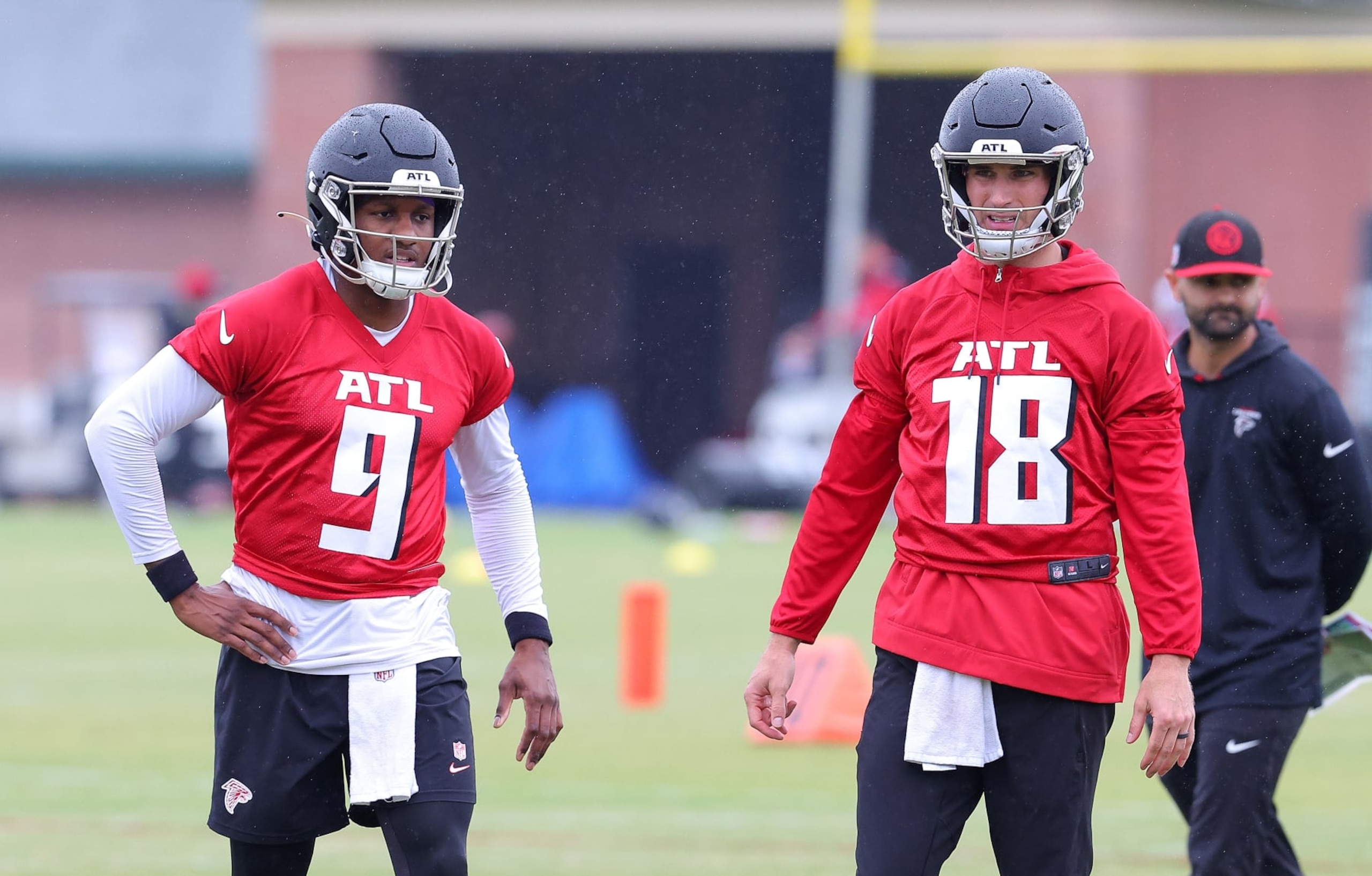 FLOWERY BRANCH, GEORGIA - MAY 14:  Quarterbacks Kirk Cousins #18 and Michael Penix Jr. #9 of the Atlanta Falcons look on during OTA offseason workouts at the Atlanta Falcons training facility on May 14, 2024 in Flowery Branch, Georgia. (Photo by Kevin C. Cox/Getty Images)