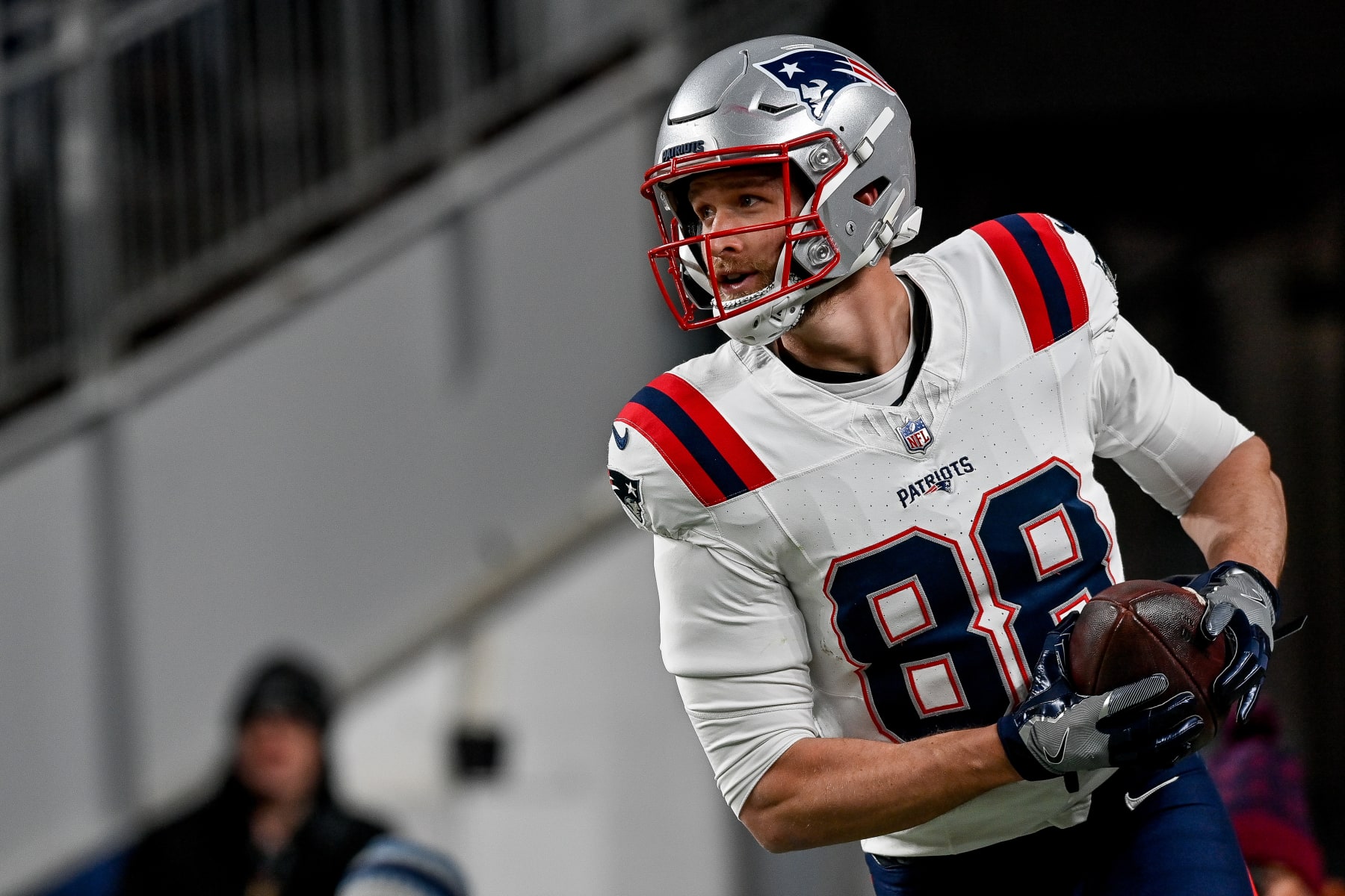 DENVER, COLORADO - DECEMBER 24:  Mike Gesicki #88 of the New England Patriots runs off the field after scoring a touchdown on a catch in the third quarter against the Denver Broncos at Empower Field at Mile High on December 24, 2023 in Denver, Colorado. (Photo by Dustin Bradford/Getty Images)