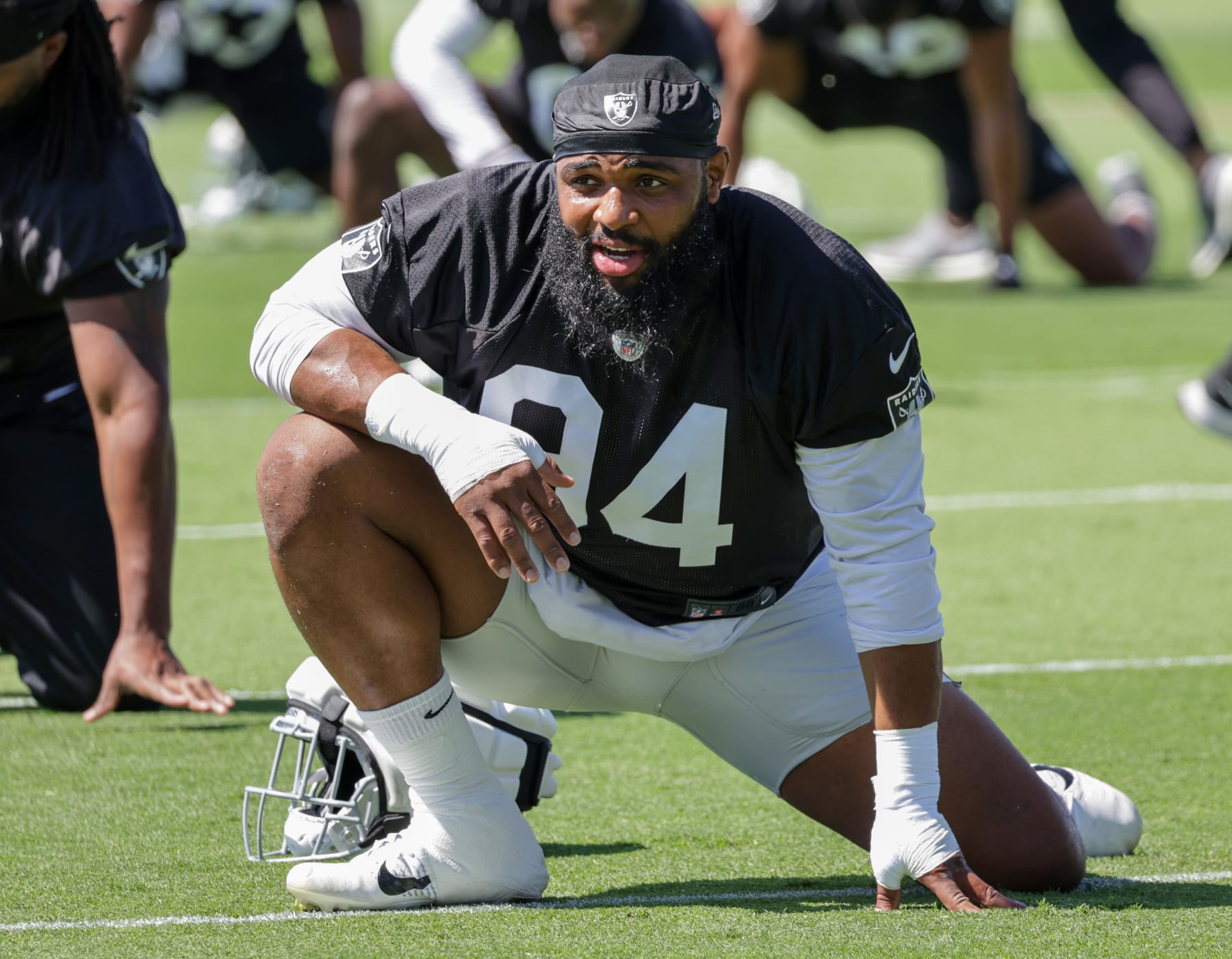 HENDERSON, NEVADA - MAY 29: Defensive tackle Christian Wilkins #94 of the Las Vegas Raiders stretches during an OTA offseason workout at the Las Vegas Raiders Headquarters/Intermountain Healthcare Performance Center on May 29, 2024 in Henderson, Nevada. (Photo by Ethan Miller/Getty Images)
