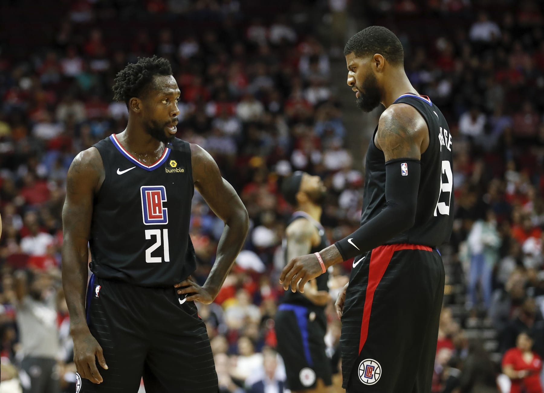 HOUSTON, TEXAS - MARCH 05: Patrick Beverley #21 of the LA Clippers talks with Paul George #13 in the first half against the Houston Rockets at Toyota Center on March 05, 2020 in Houston, Texas. NOTE TO USER: User expressly acknowledges and agrees that, by downloading and or using this photograph, User is consenting to the terms and conditions of the Getty Images License Agreement. (Photo by Tim Warner/Getty Images)