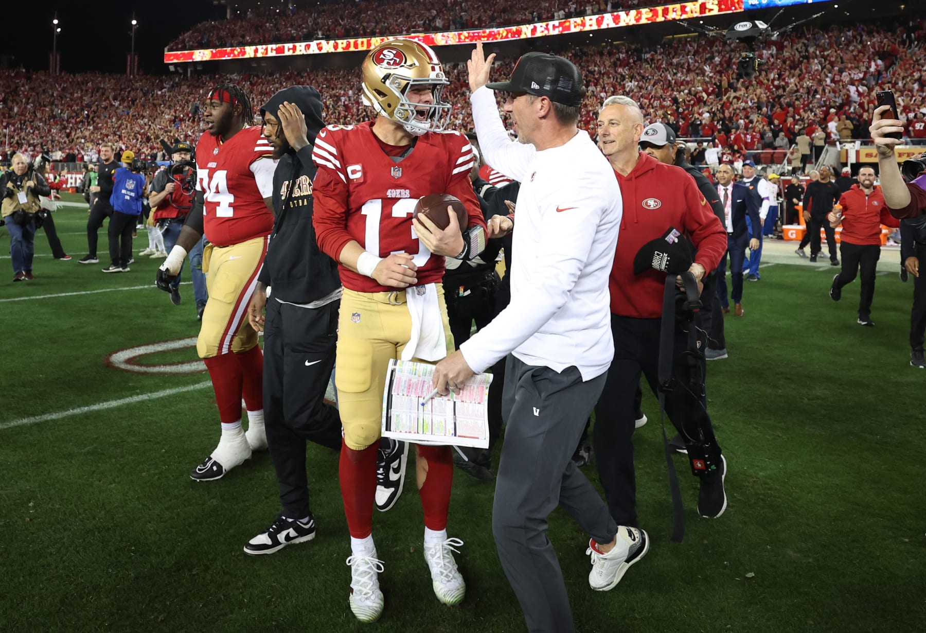 SANTA CLARA, CALIFORNIA - JANUARY 28: Brock Purdy #13 of the San Francisco 49ers celebrates with Head coach Kyle Shanahan after defeating the Detroit Lions 34-31 in the NFC Championship Game at Levi's Stadium on January 28, 2024 in Santa Clara, California. (Photo by Ezra Shaw/Getty Images)