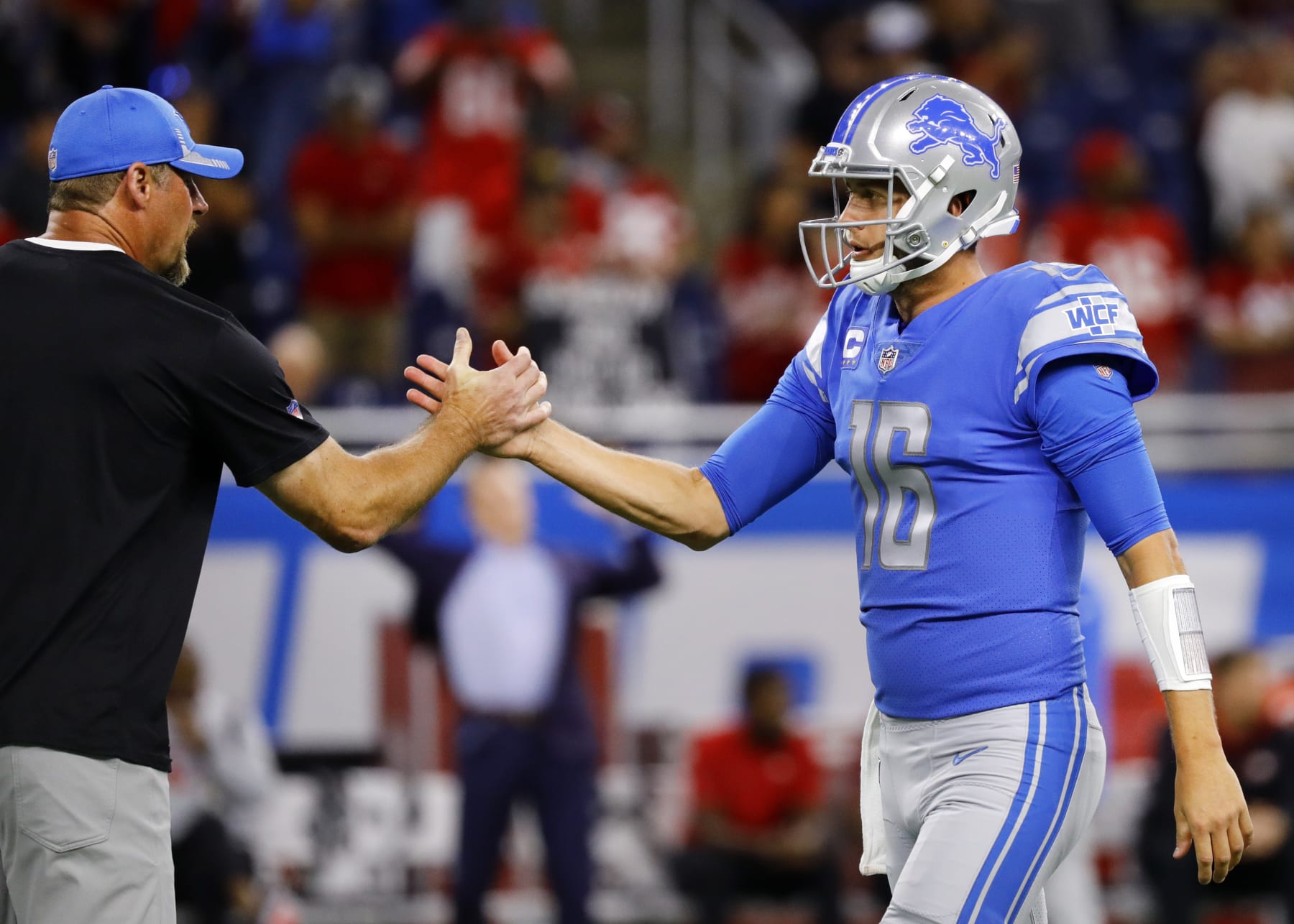 DETROIT, MICHIGAN - SEPTEMBER 12: Head coach Dan Campbell of the Detroit Lions congratulates Jared Goff #16 during the first half against the San Francisco 49ers at Ford Field on September 12, 2021 in Detroit, Michigan. (Photo by Leon Halip/Getty Images)