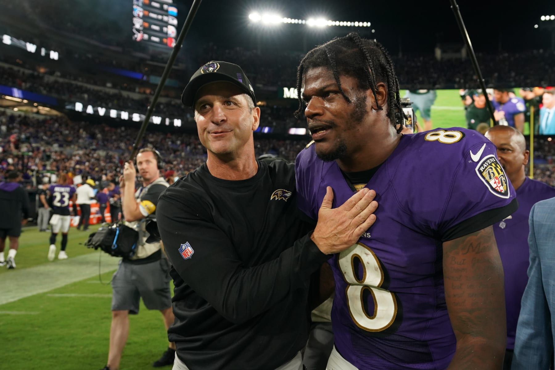 Baltimore Ravens head coach John Harbaugh (left) and quarterback Lamar Jackson (right)