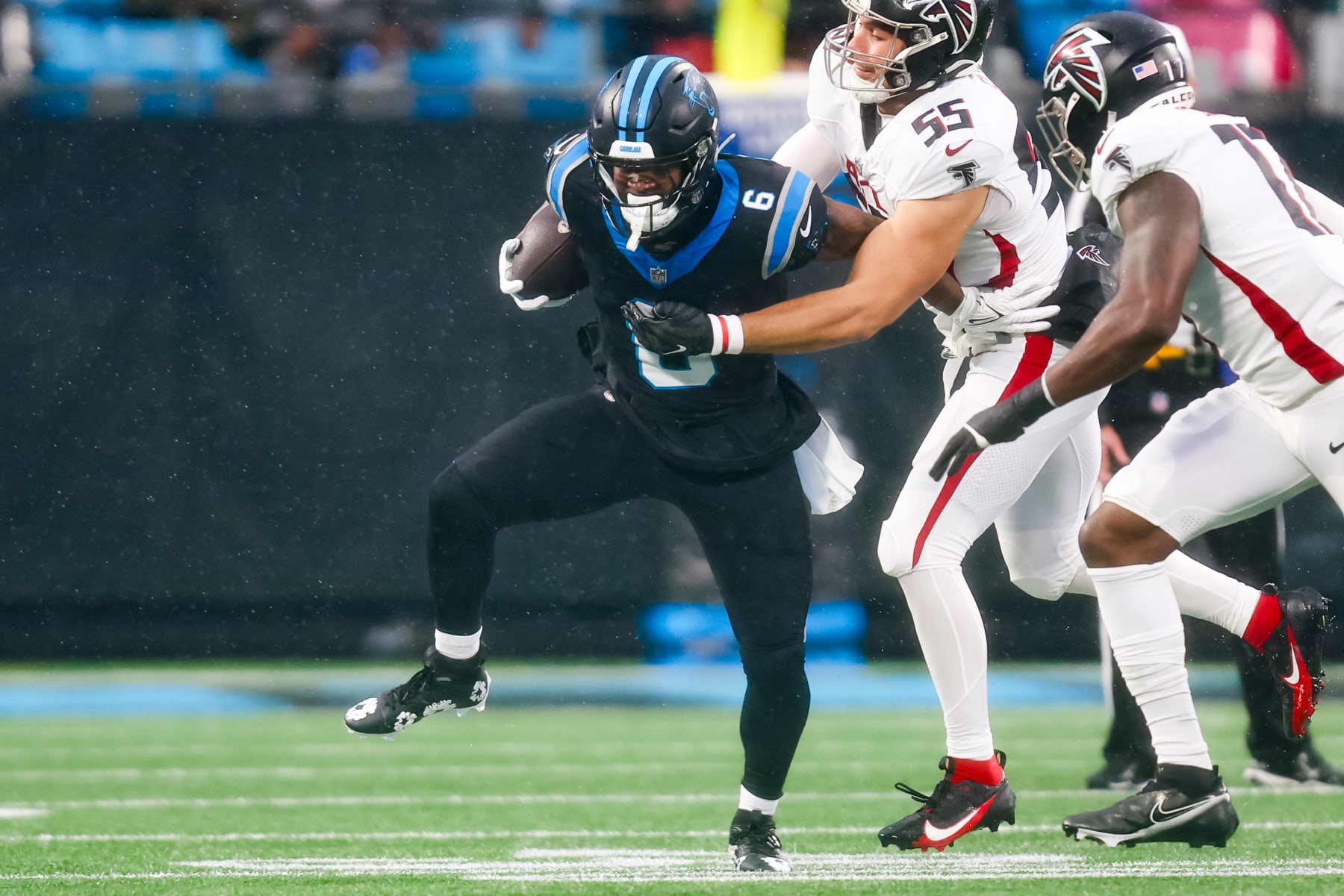 CHARLOTTE, NC - DECEMBER 17: Kaden Elliss #55 of the Atlanta Falcons tackles Miles Sanders #6 of the Carolina Panthers during an NFL game at Bank of America Stadium in Charlotte, North Carolina on Dec 17, 2023. (Photo by David Jensen/Icon Sportswire via Getty Images)