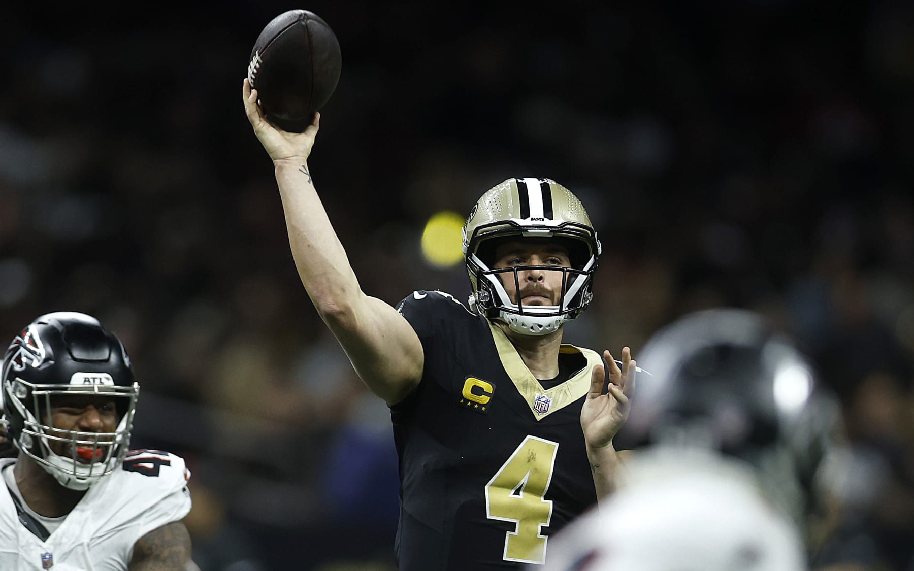 NEW ORLEANS, LOUISIANA - JANUARY 07: Derek Carr #4 of the New Orleans Saints throws the ball under pressure in the first half during a game against the Atlanta Falcons at Caesars Superdome on January 07, 2024 in New Orleans, Louisiana. (Photo by Chris Graythen/Getty Images)