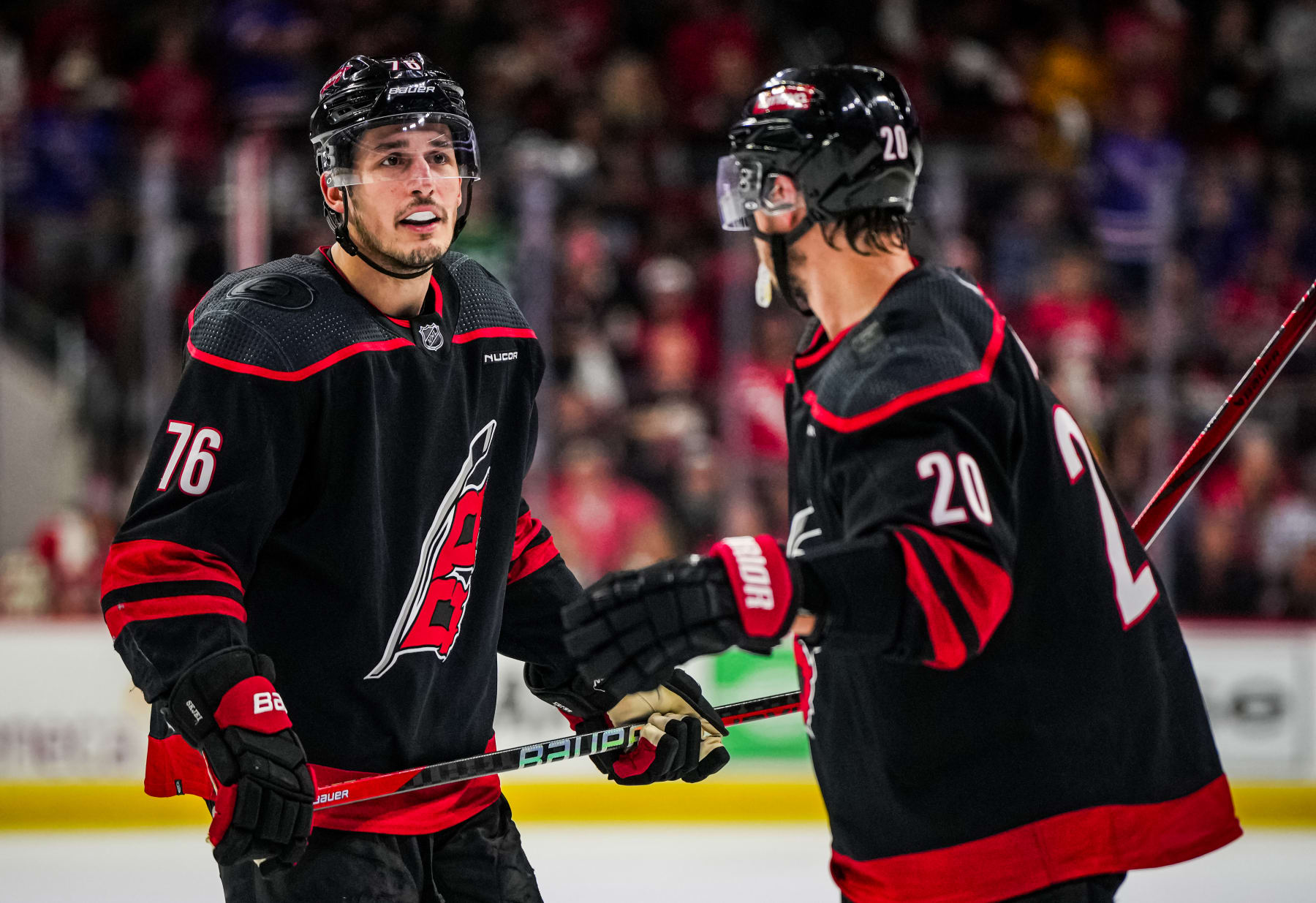 RALEIGH, NORTH CAROLINA - MAY 16: Brady Skjei #76 of the Carolina Hurricanes talks with Sebastian Aho #20 during the third period against the New York Rangers in Game Six of the Second Round of the 2024 Stanley Cup Playoffs at PNC Arena on May 16, 2024 in Raleigh, North Carolina. (Photo by Josh Lavallee/NHLI via Getty Images)