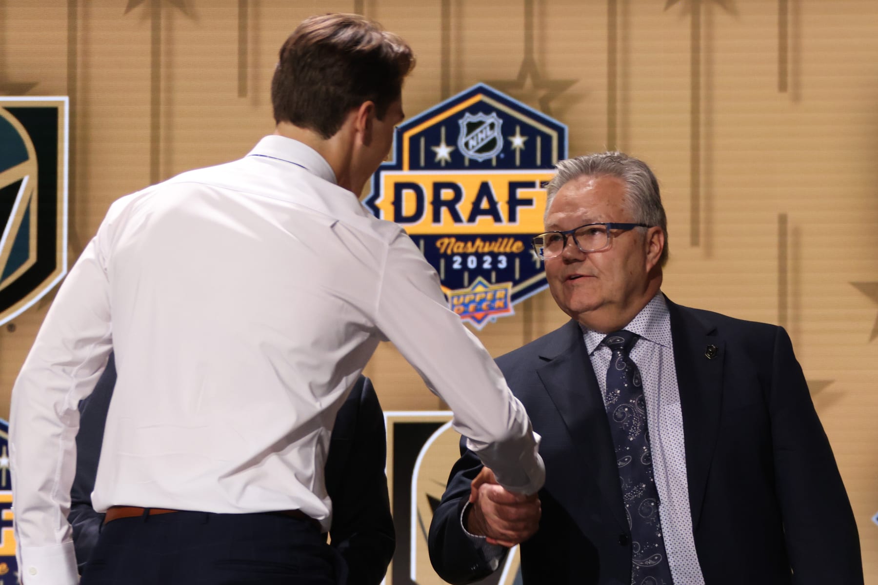 NASHVILLE, TENNESSEE - JUNE 28: David Edstrom shakes the hand of general manager Kelly McCrimmon of the Vegas Golden Knights onstage after being selected 32nd overall by the Vegas Golden Knights during the 2023 Upper Deck NHL Draft - Round One at Bridgestone Arena on June 28, 2023 in Nashville, Tennessee. (Photo by Dave Sandford/NHLI via Getty Images)