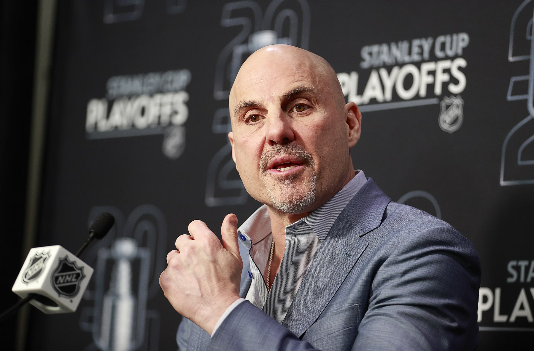 VANCOUVER, CANADA - MAY 20: Head coach Rick Tocchet of the Vancouver Canucks talks during a press conference at the end of Game Seven of the Second Round of the 2024 Stanley Cup Playoffs against the Edmonton Oilers at Rogers Arena on May 20, 2024 in Vancouver, British Columbia, Canada. Edmonton won 3-2 and take the series 4-3. (Photo by Jeff Vinnick/NHLI via Getty Images)