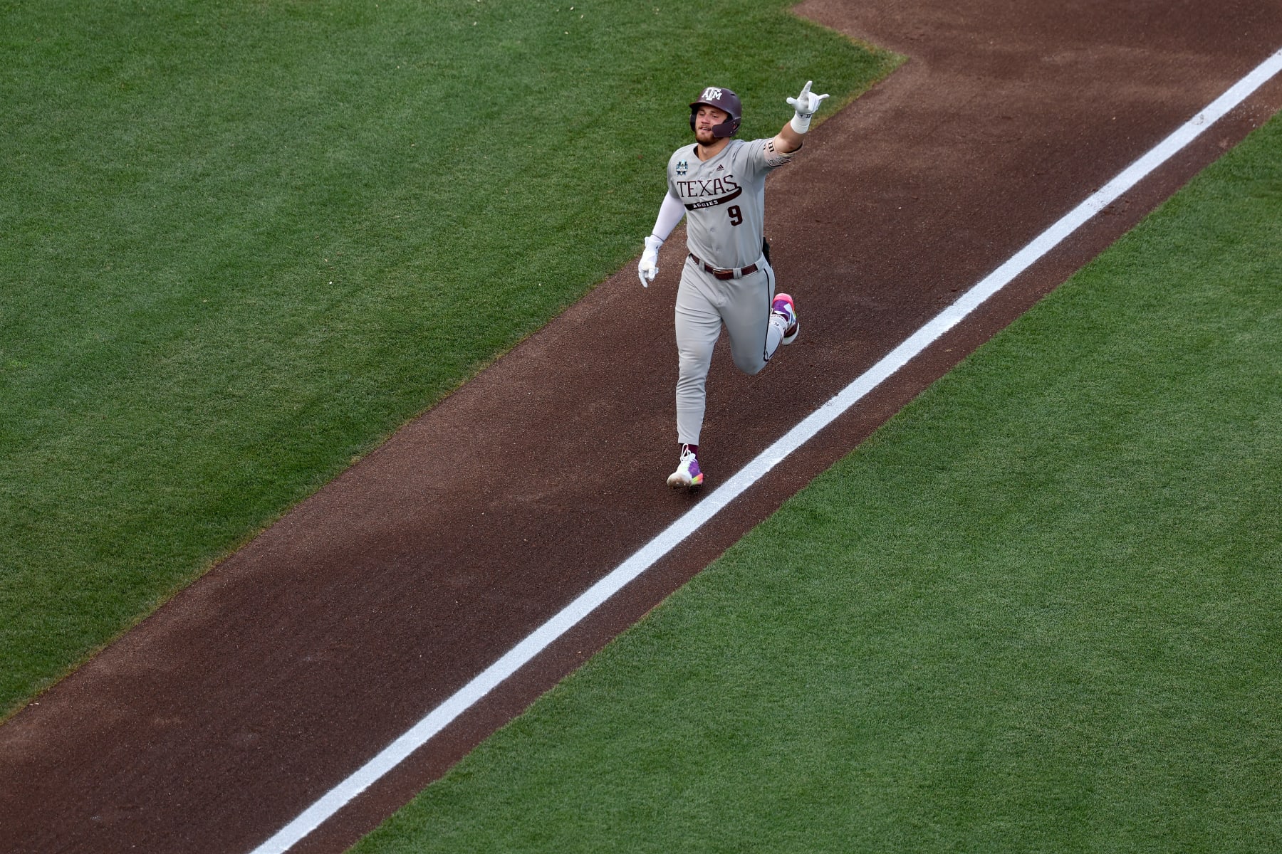 OMAHA, NEBRASKA - JUNE 22: Gavin Grahovac #9 of the Texas A&M Aggies celebrates after hitting a home run against the Tennessee Volunteers during the Division I Men's Baseball Championship held at Charles Schwab Field on June 22, 2024 in Omaha, Nebraska. (Photo by Jamie Schwaberow/NCAA Photos via Getty Images)