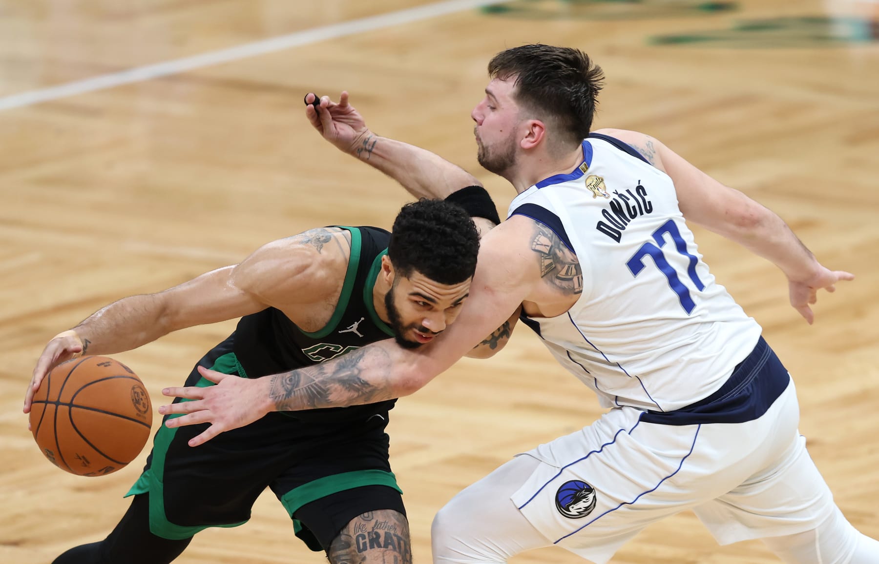 BOSTON, MASSACHUSETTS - JUNE 09: Jayson Tatum #0 of the Boston Celtics drives to the basket against Luka Doncic #77 of the Dallas Mavericks during the second quarter in Game Two of the 2024 NBA Finals at TD Garden on June 09, 2024 in Boston, Massachusetts. NOTE TO USER: User expressly acknowledges and agrees that, by downloading and or using this photograph, User is consenting to the terms and conditions of the Getty Images License Agreement. (Photo by Adam Glanzman/Getty Images)