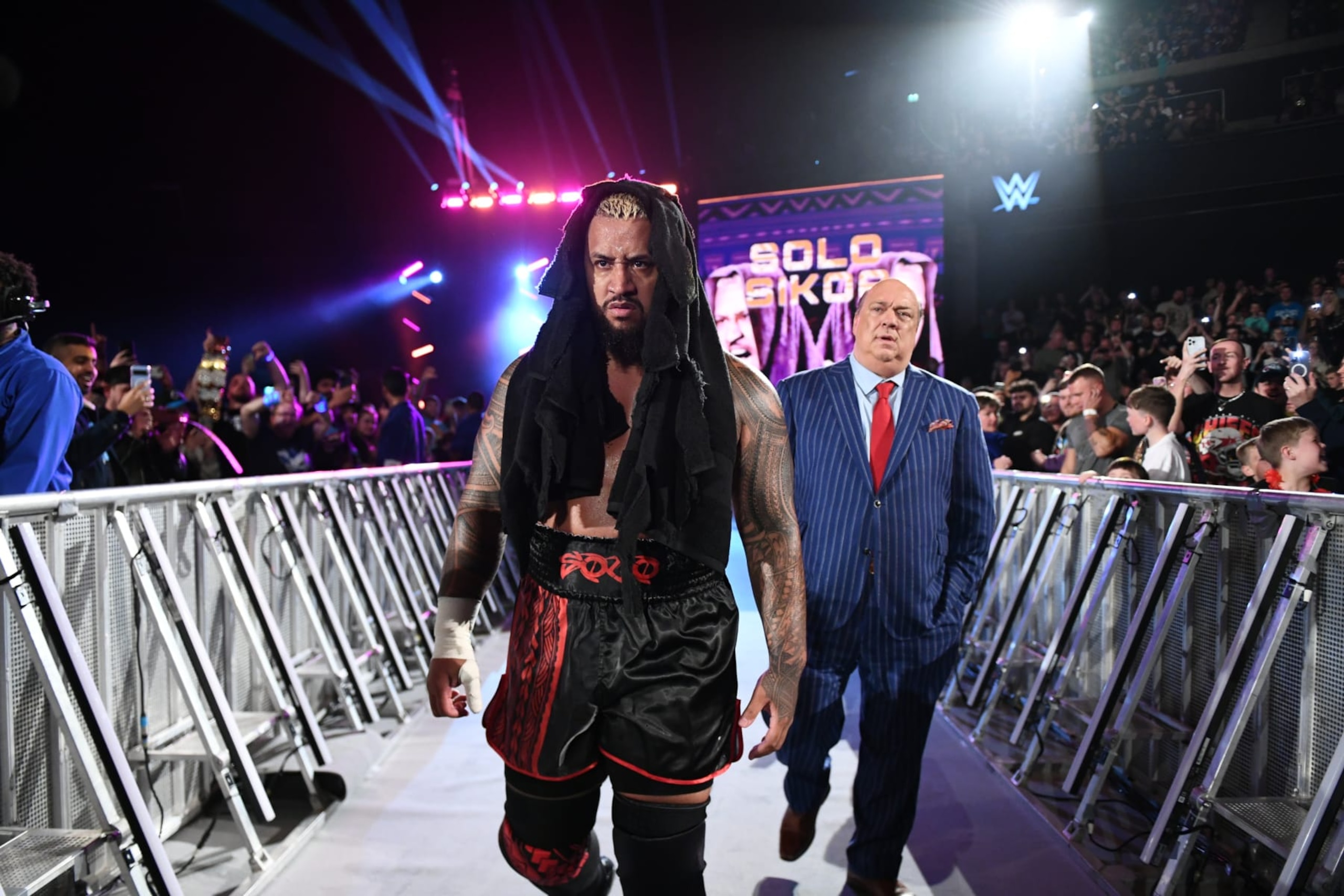 GLASGOW, SCOTLAND - JUNE 14: Solo Sikoa and Paul Heyman make their entrance during SmackDown at The OVO Hydro on June 14, 2024 in Glasgow, Scotland.  (Photo by WWE/Getty Images)