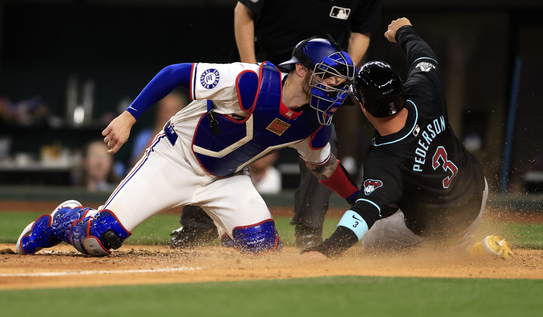 ARLINGTON, TX - MAY 28: Joc Pederson #3 of the Arizona Diamondbacks is tagged out at the plate by Jonah Heim #28 of the Texas Rangers during the sixth inning at Globe Life Field on May 28, 2024 in Arlington, Texas. (Photo by Ron Jenkins/Getty Images)