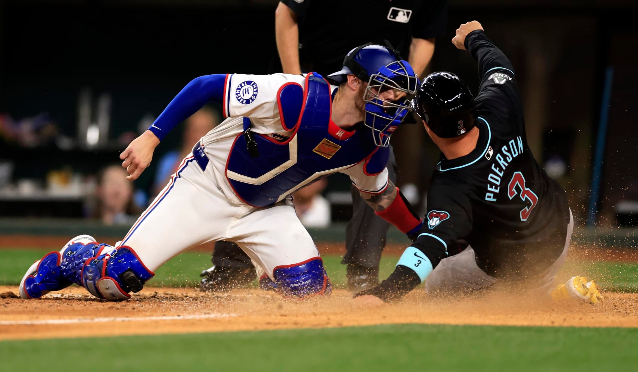 ARLINGTON, TX - MAY 28: Joc Pederson #3 of the Arizona Diamondbacks is tagged out at the plate by Jonah Heim #28 of the Texas Rangers during the sixth inning at Globe Life Field on May 28, 2024 in Arlington, Texas. (Photo by Ron Jenkins/Getty Images)